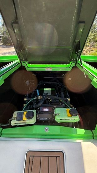 The engine compartment of a green 2018 Nautique Super Air Nautique G23 boat is open.