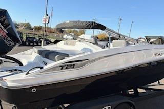 2026 Tahoe T21 boat with sleek design, parked on a trailer under clear blue sky.