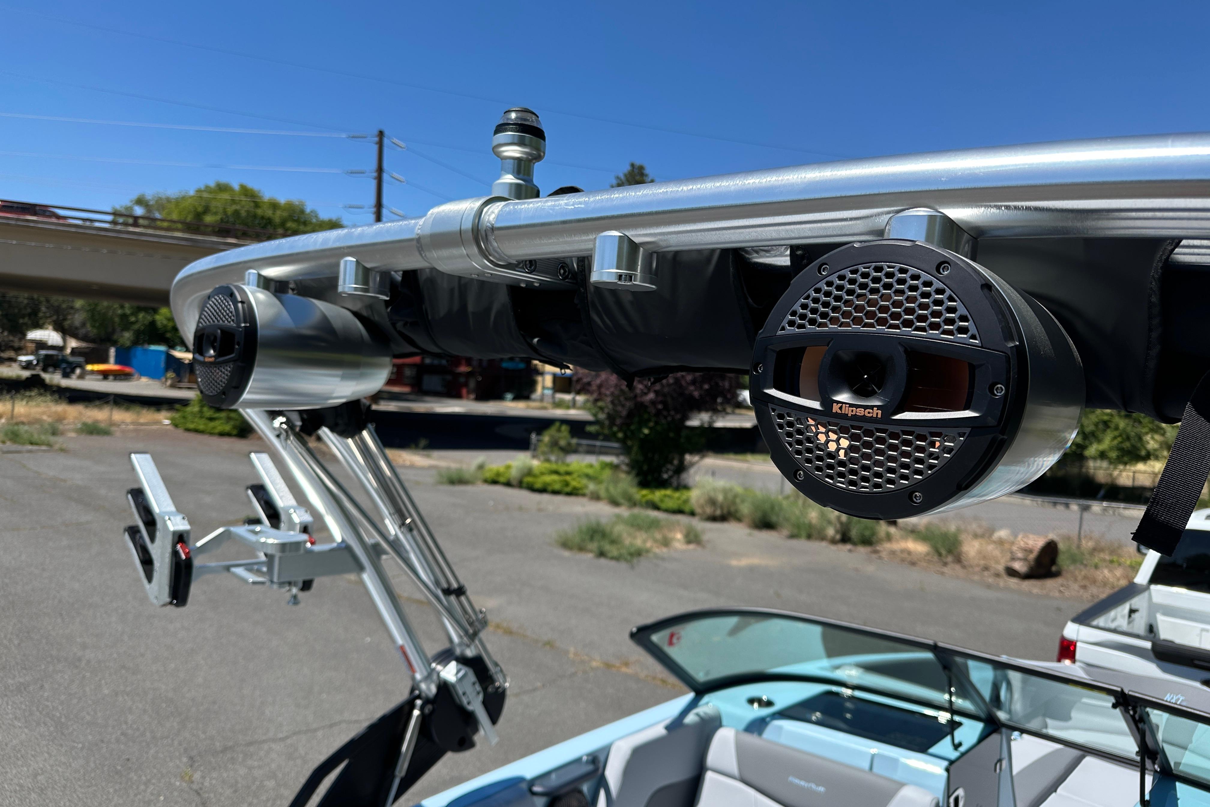 2023 MasterCraft NXT23 boat with Klipsch speakers and wakeboard racks on tower.