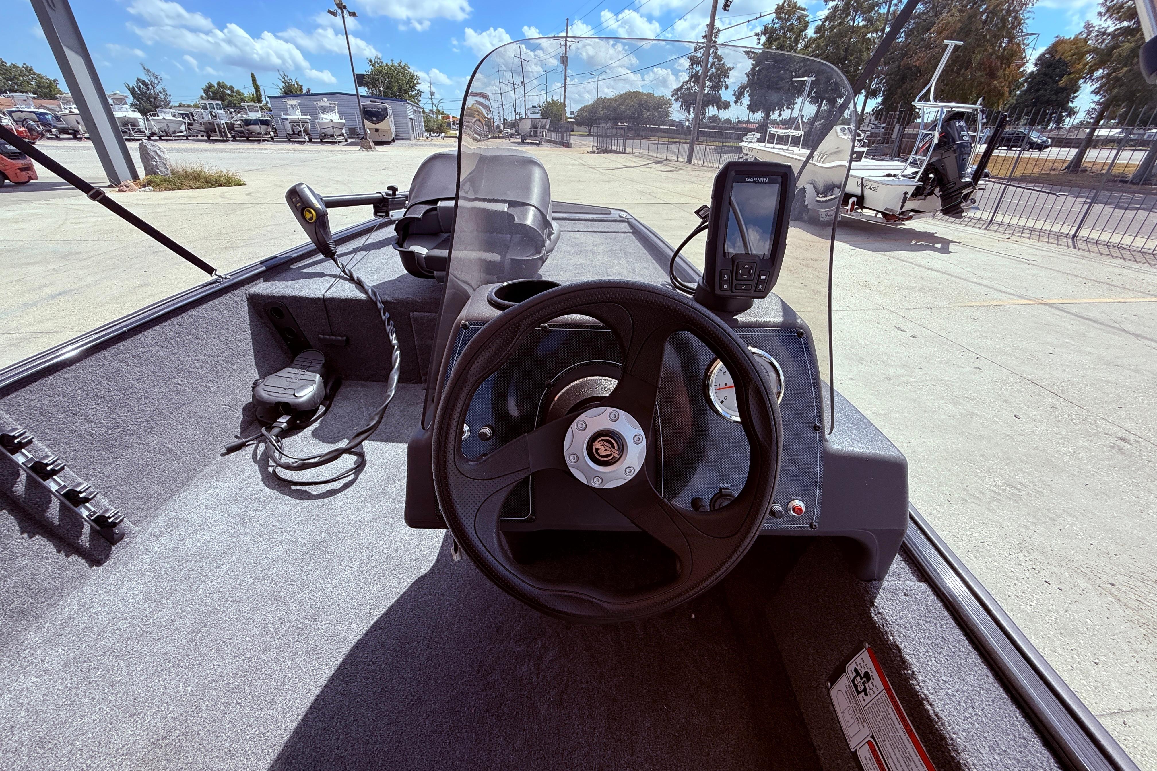 2025 Bass Tracker Classic XL boat interior with steering wheel and navigation equipment.