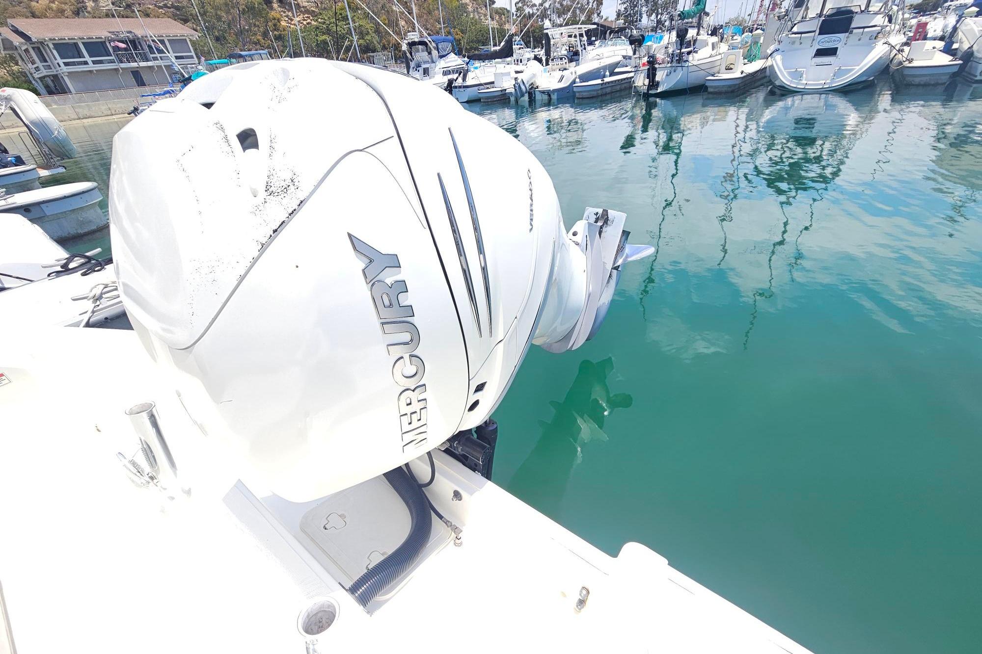 Boston Whaler 230 Outrage 2017 with Mercury engine docked in marina.
