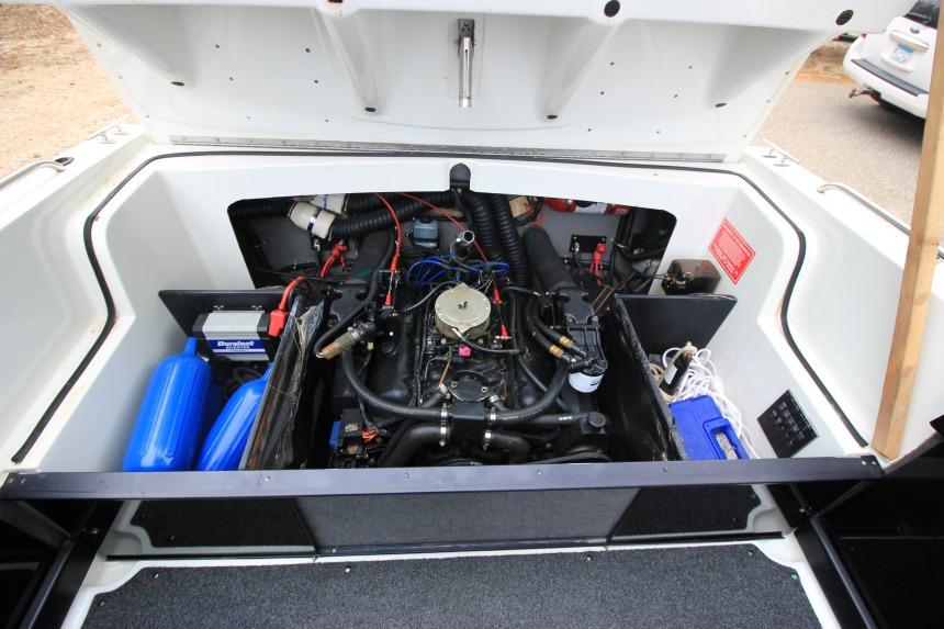 1989 Formula 223 SS boat engine compartment with visible components and storage.