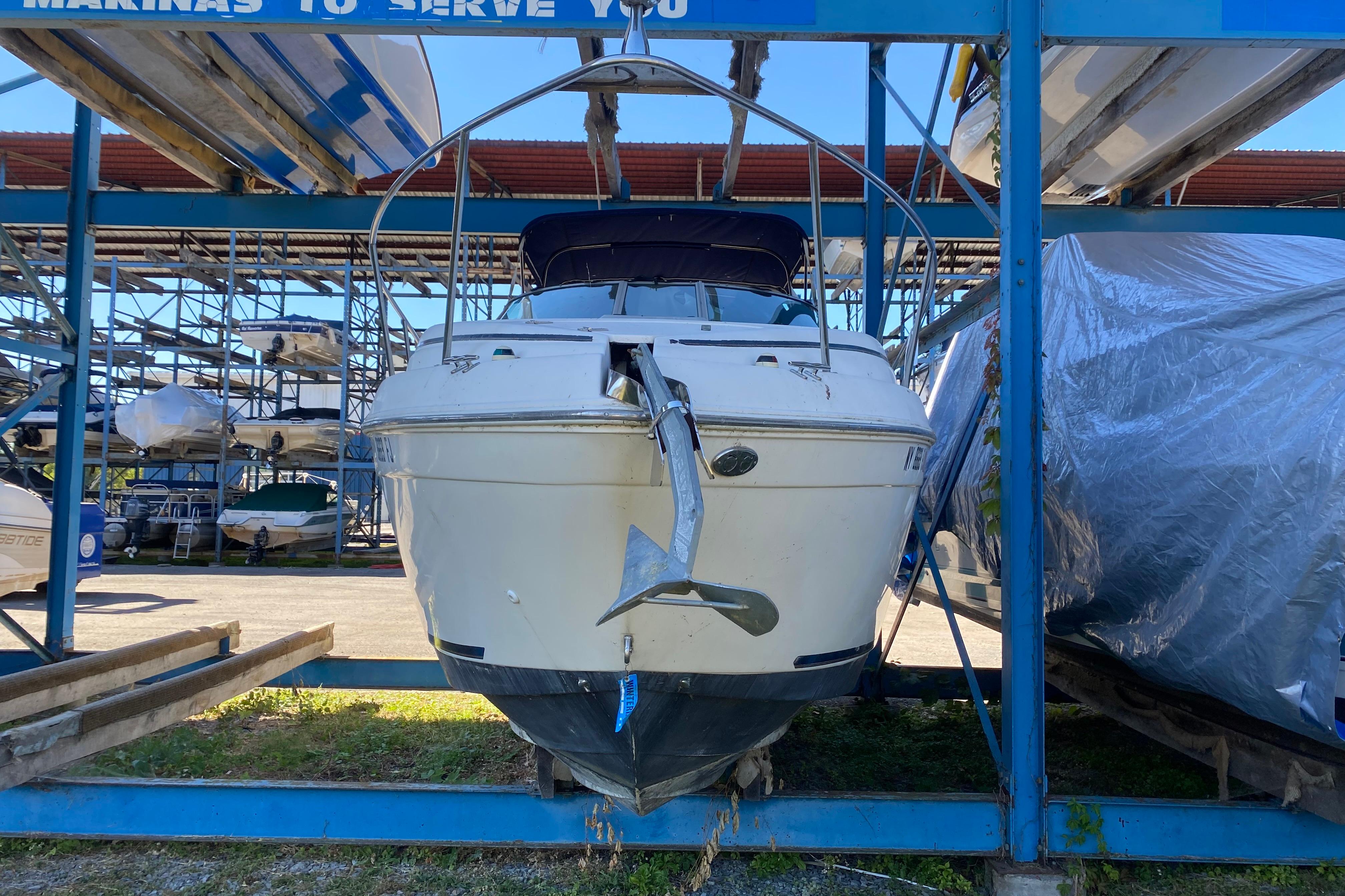 2003 Rinker Fiesta Vee 270 boat stored in a marina rack, front view.