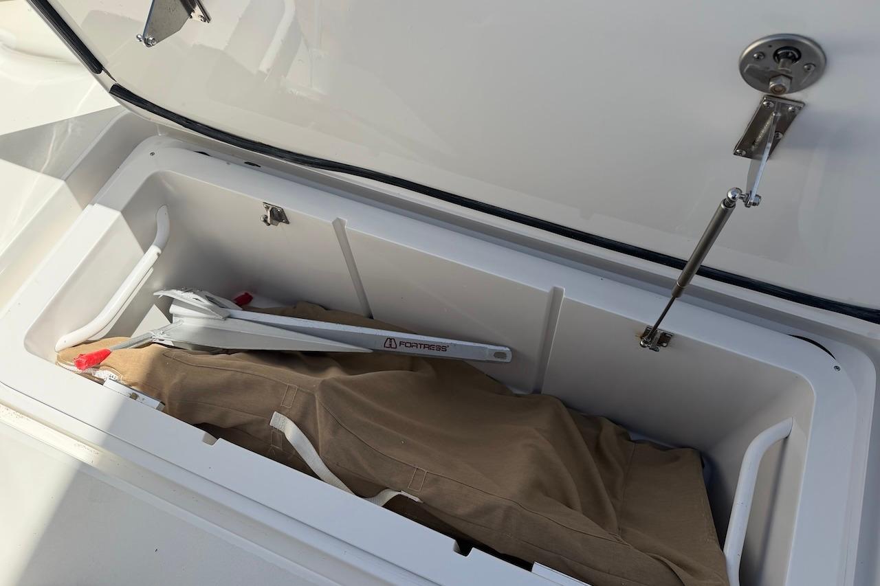 Storage compartment on a 2012 Viking 50 Convertible boat with anchor and cover.