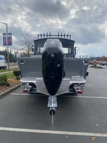 2025 Spartan 240 Maximus boat with powerful outboard motor in parking lot.