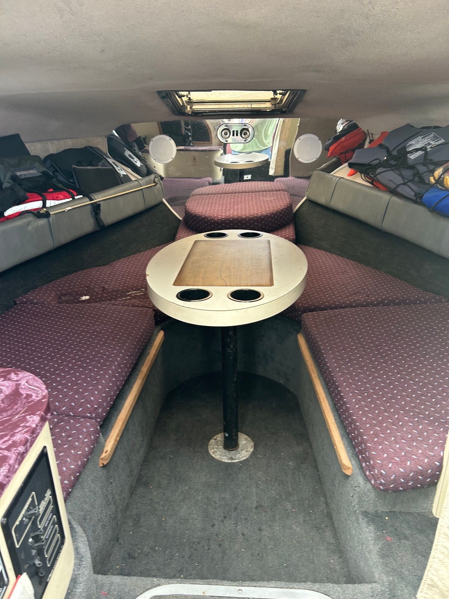 Interior of a 1992 Crownline Cudy Cruser with seating area and table.