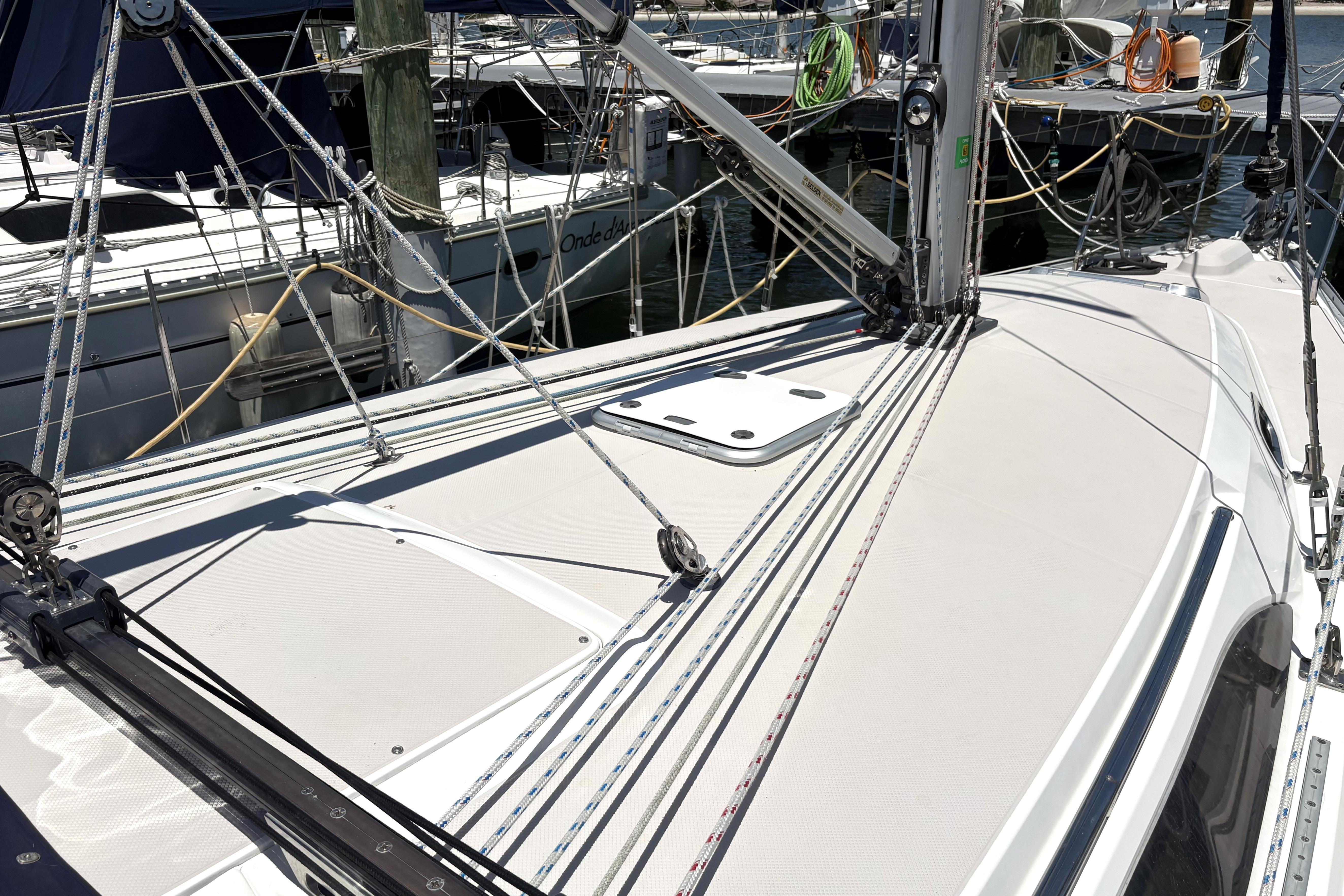 Sailboat deck of a 2011 Catalina 355, featuring rigging and docked at a marina.