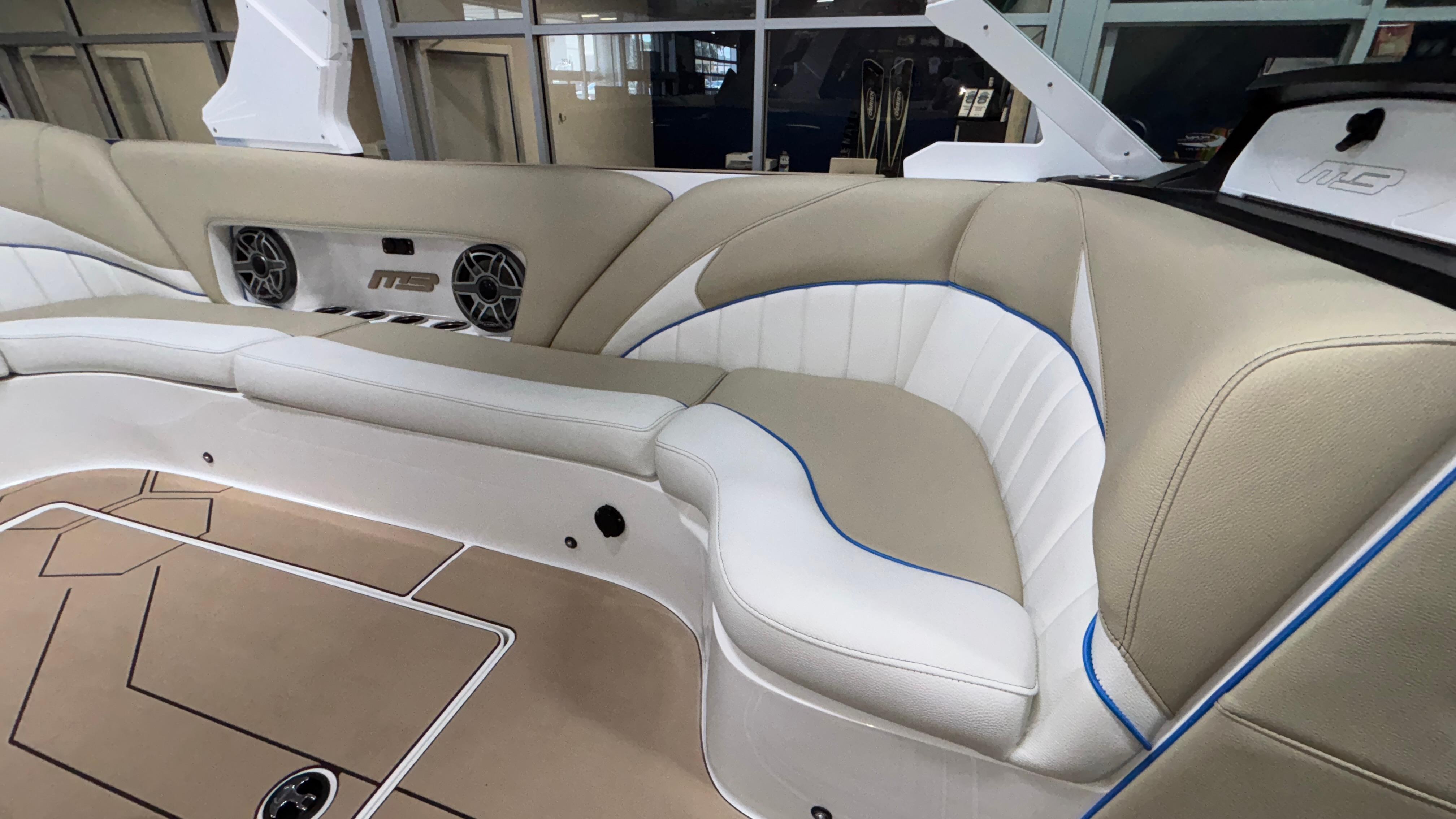 Luxurious interior of 2025 MB B52 23 Classic boat with beige and white seating.