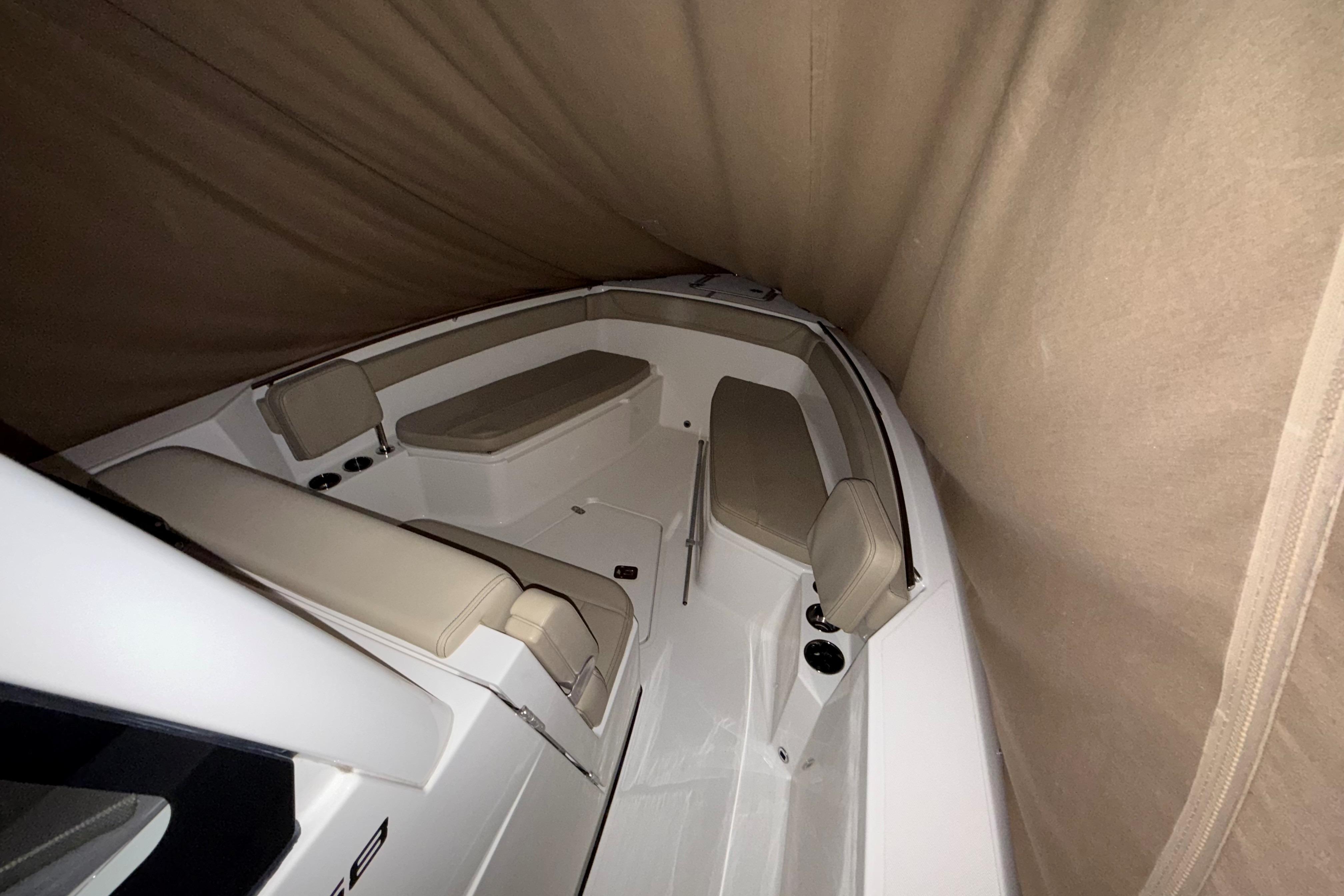 2021 Pursuit S 268 Sport boat interior with beige seating and protective cover.