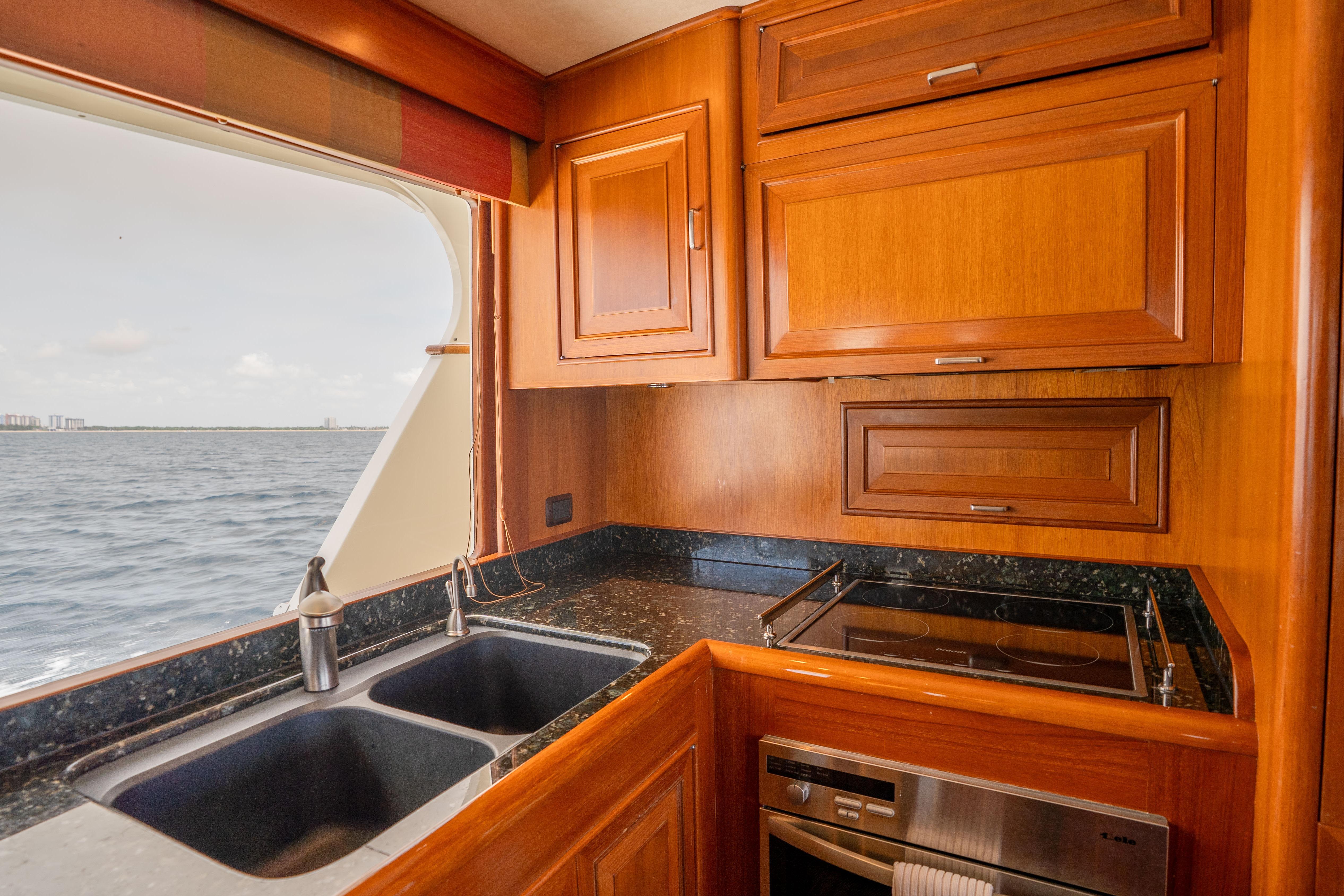 Luxurious kitchen interior of 2006 Fleming 75 yacht with ocean view.