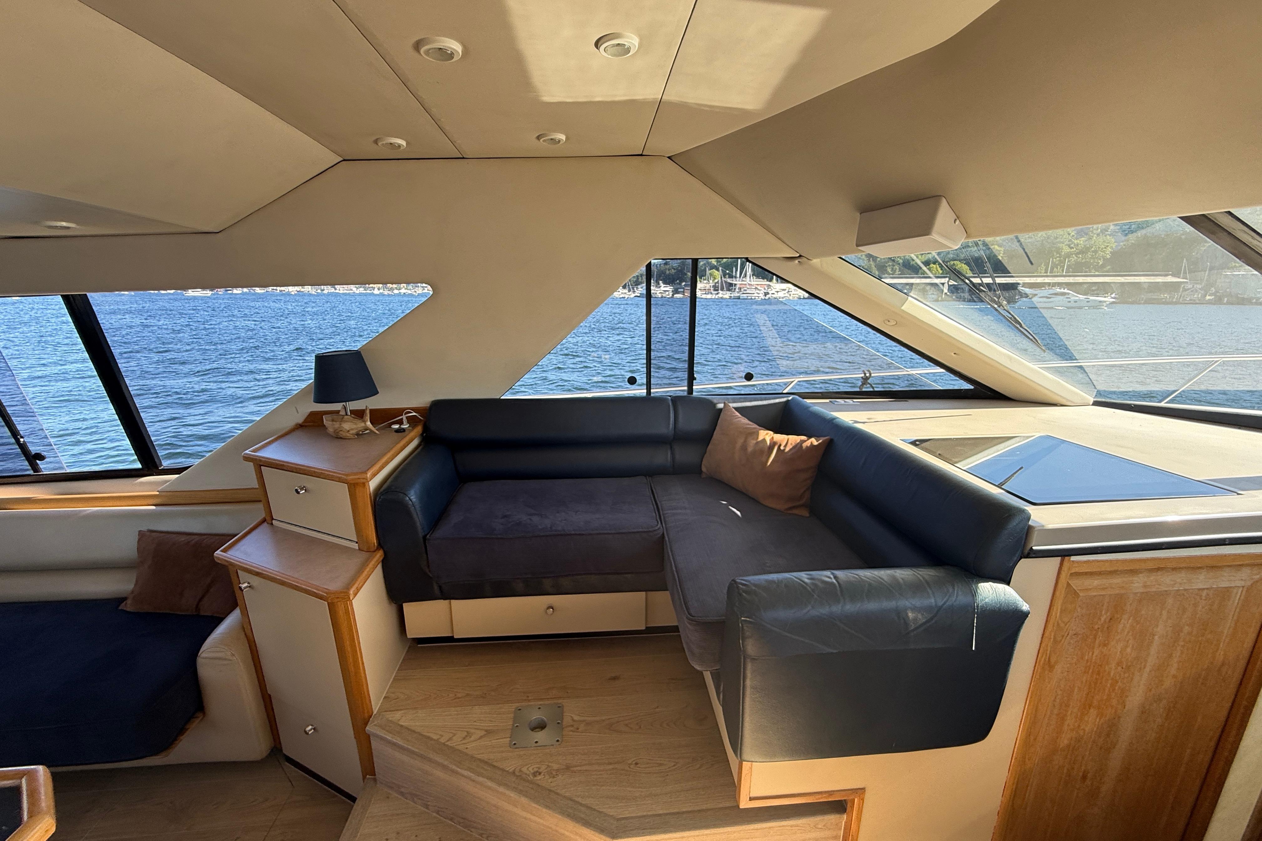 Luxurious interior of 1997 Bayliner 3988 Command Bridge Motoryacht with waterfront view.