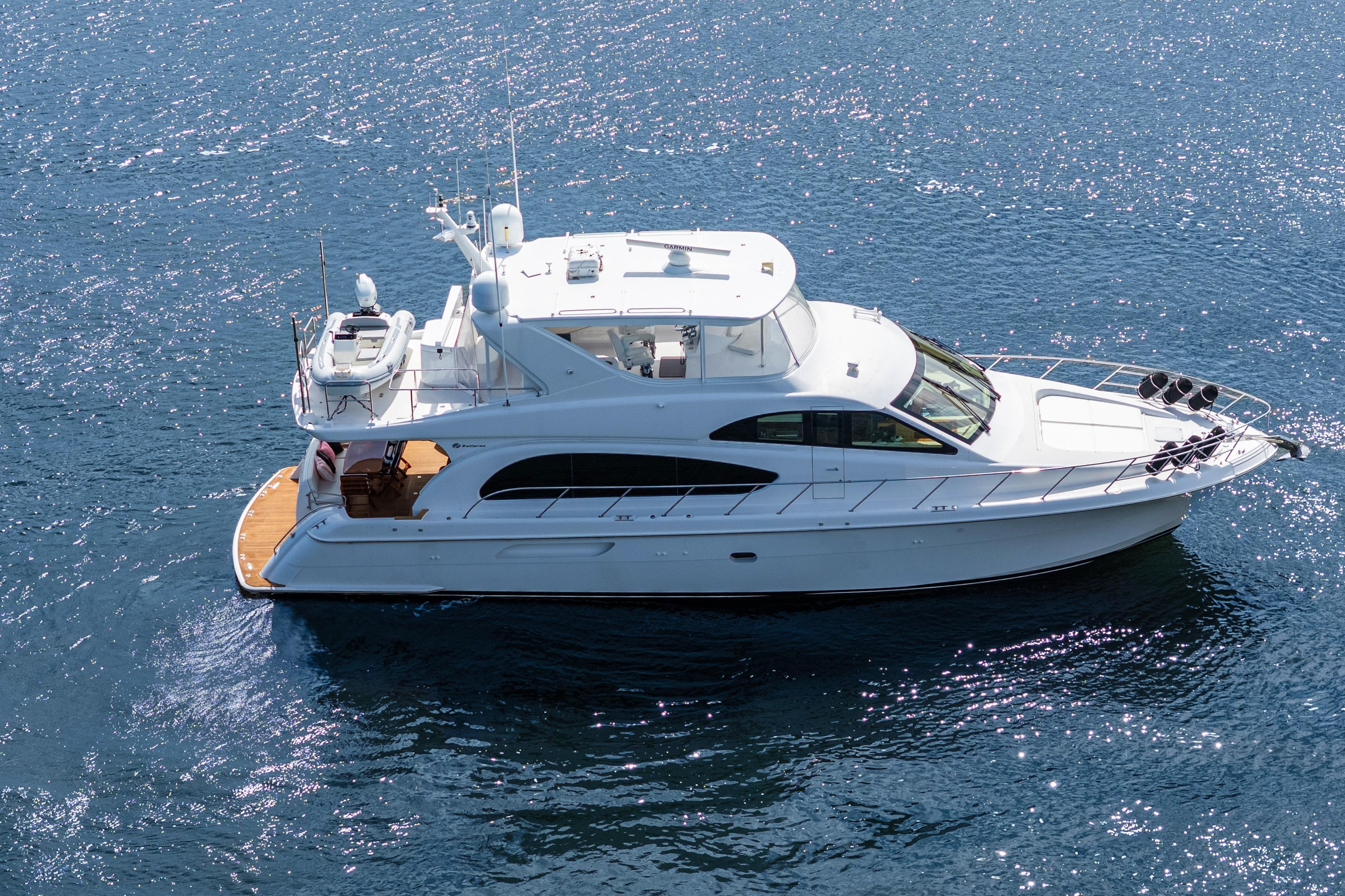 2008 Hatteras 64 Motor Yacht cruising on sparkling blue water.