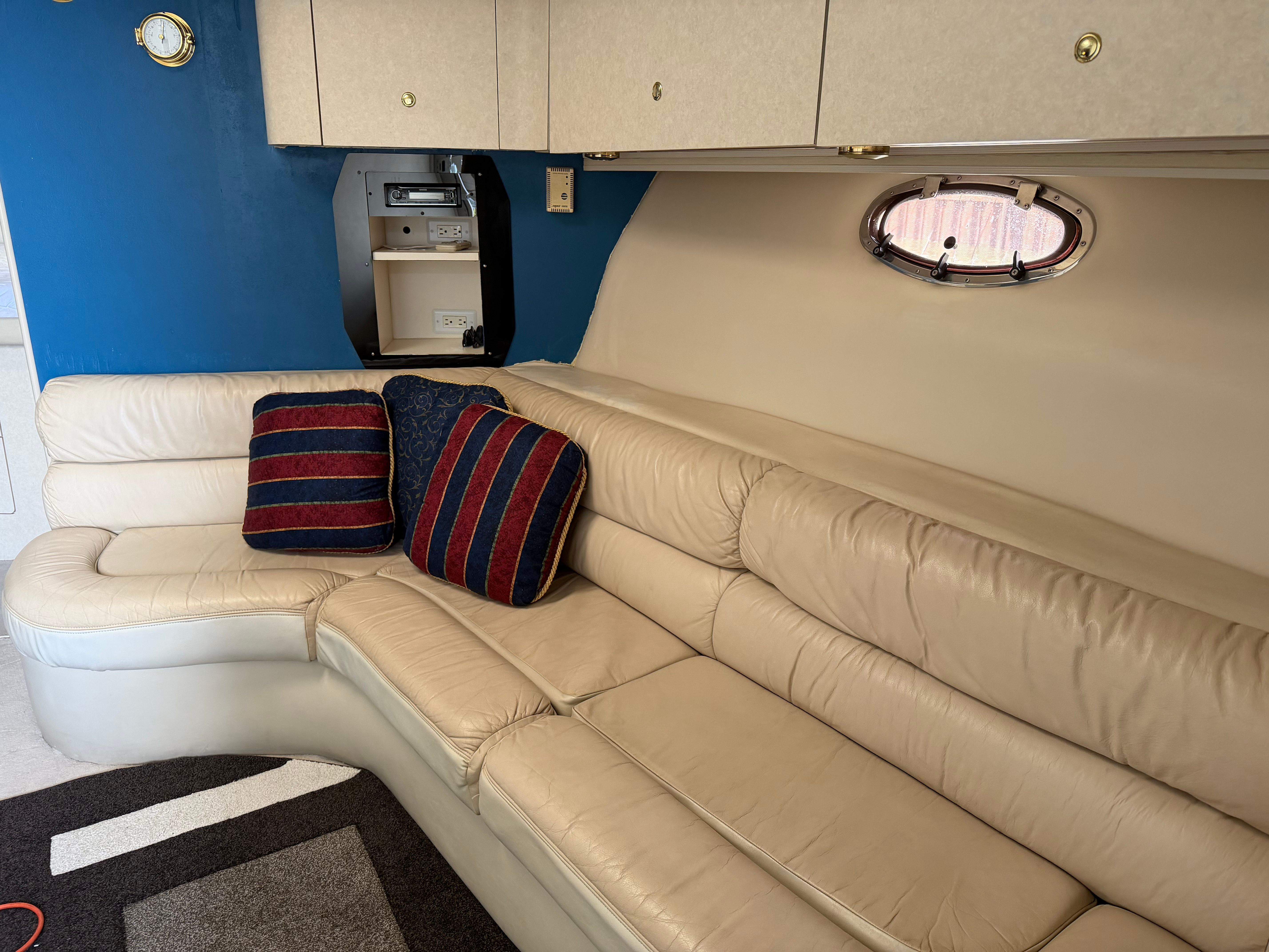 Interior of a 1997 Regal Commodore with beige sofa and cushions.