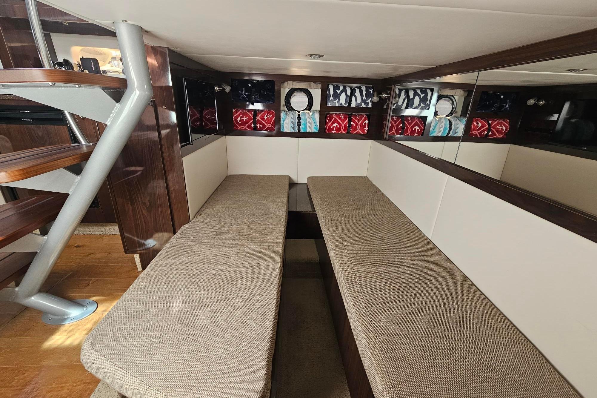 Interior of 2016 Sea Ray Sundancer 350, featuring cozy seating and elegant wooden accents.