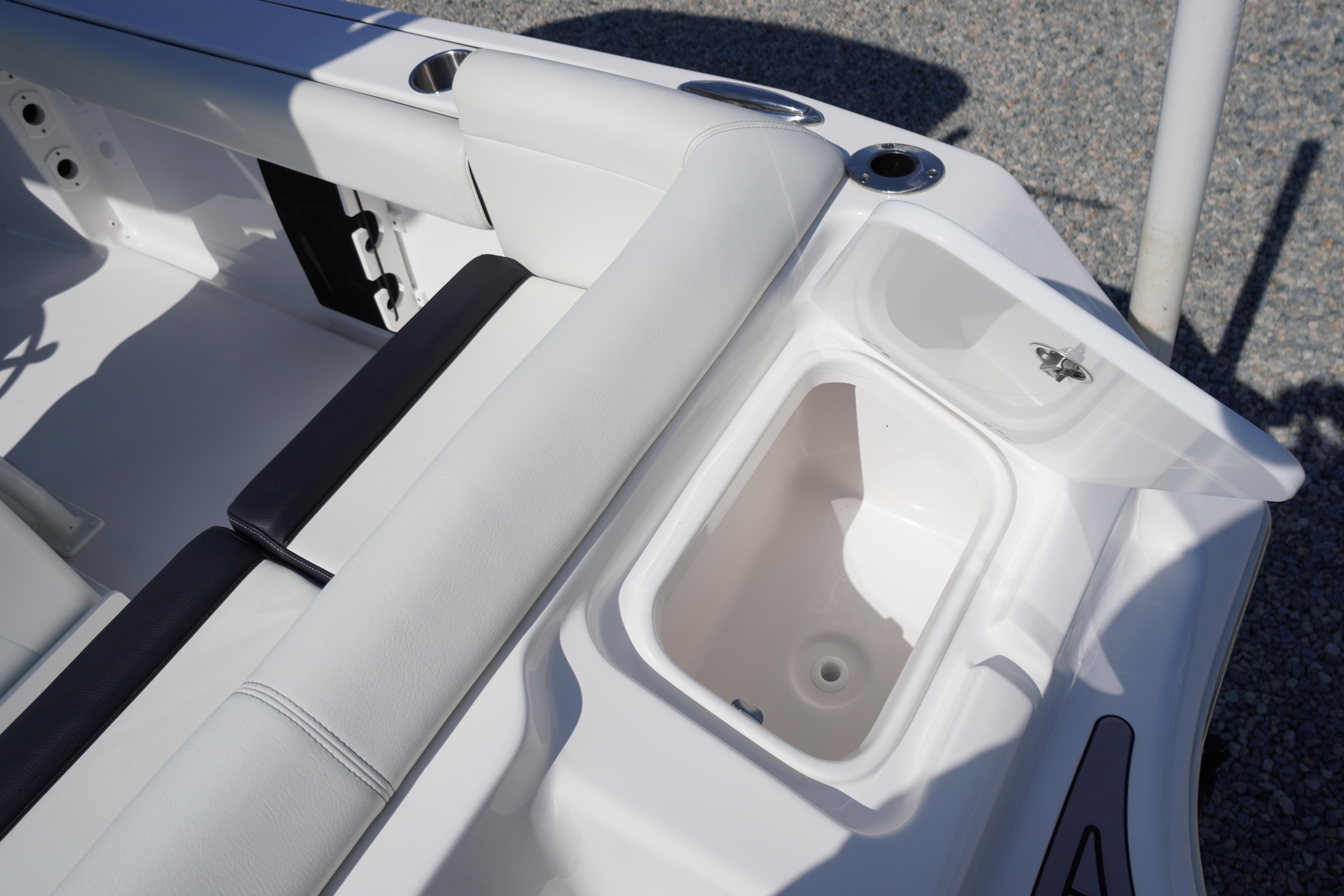 2025 Tidewater 232 SS boat interior with open storage compartment and seating.
