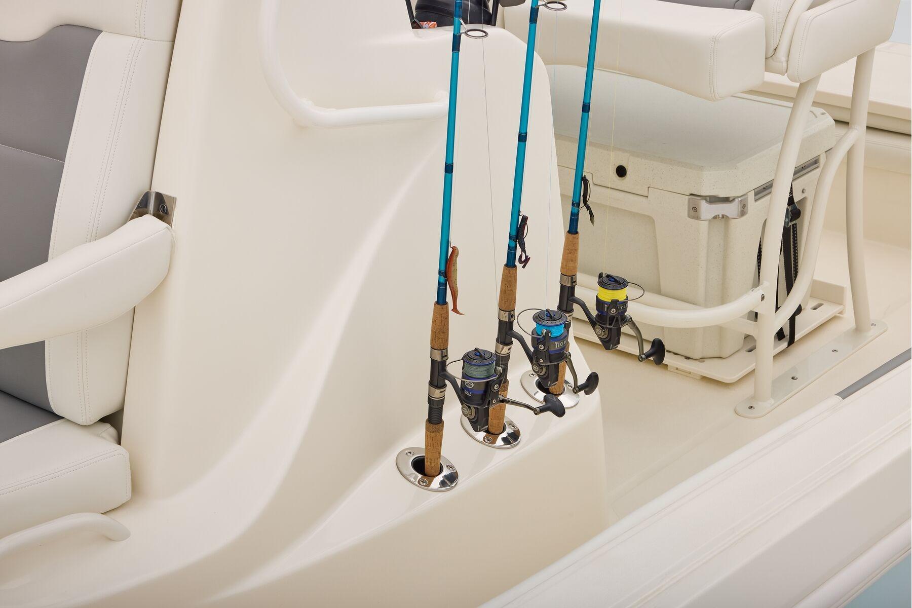 Fishing rods on a 2026 Mako 24 APEX boat with cushioned seating.