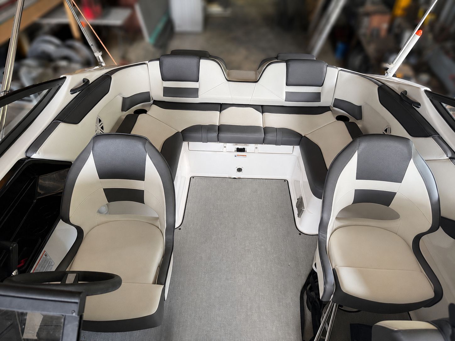 The image shows the cockpit of a 2021 Yamaha SX210 boat with gray and white seating.