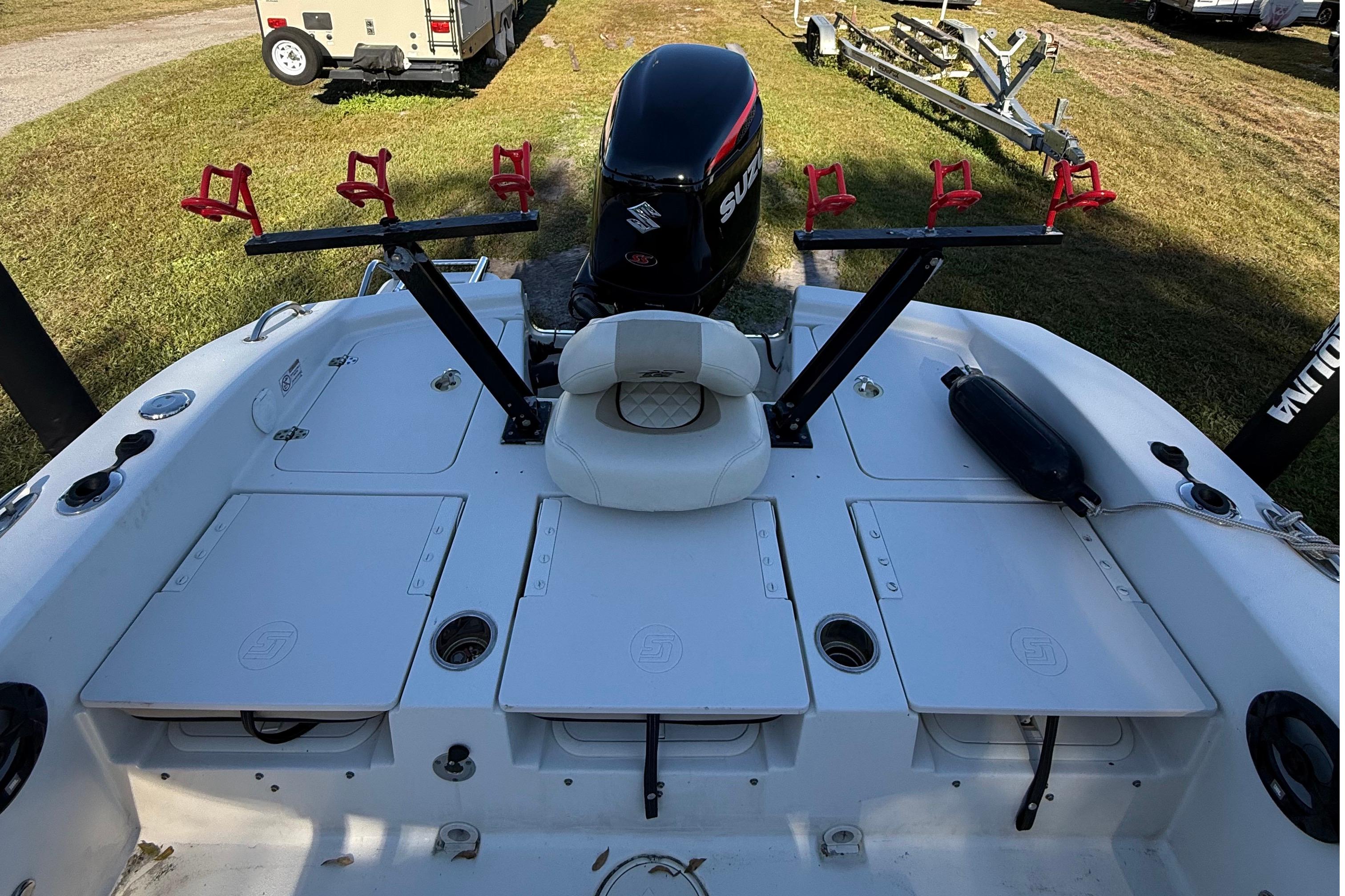 2021 Carolina Skiff 26 Ultra Elite boat with Suzuki outboard motor and rod holders.
