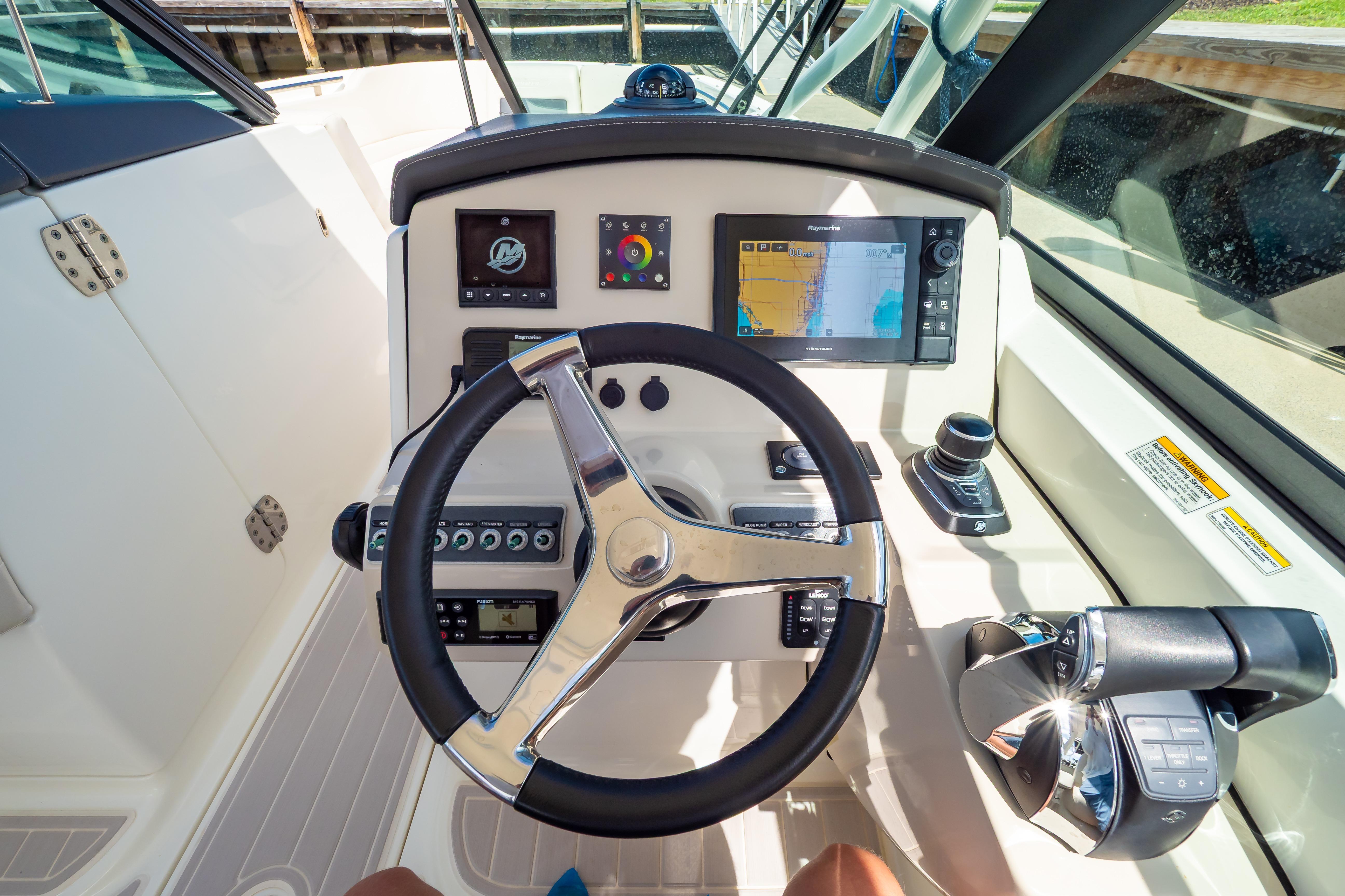 2019 Boston Whaler 270 Vantage helm with steering wheel, navigation screens, and controls.