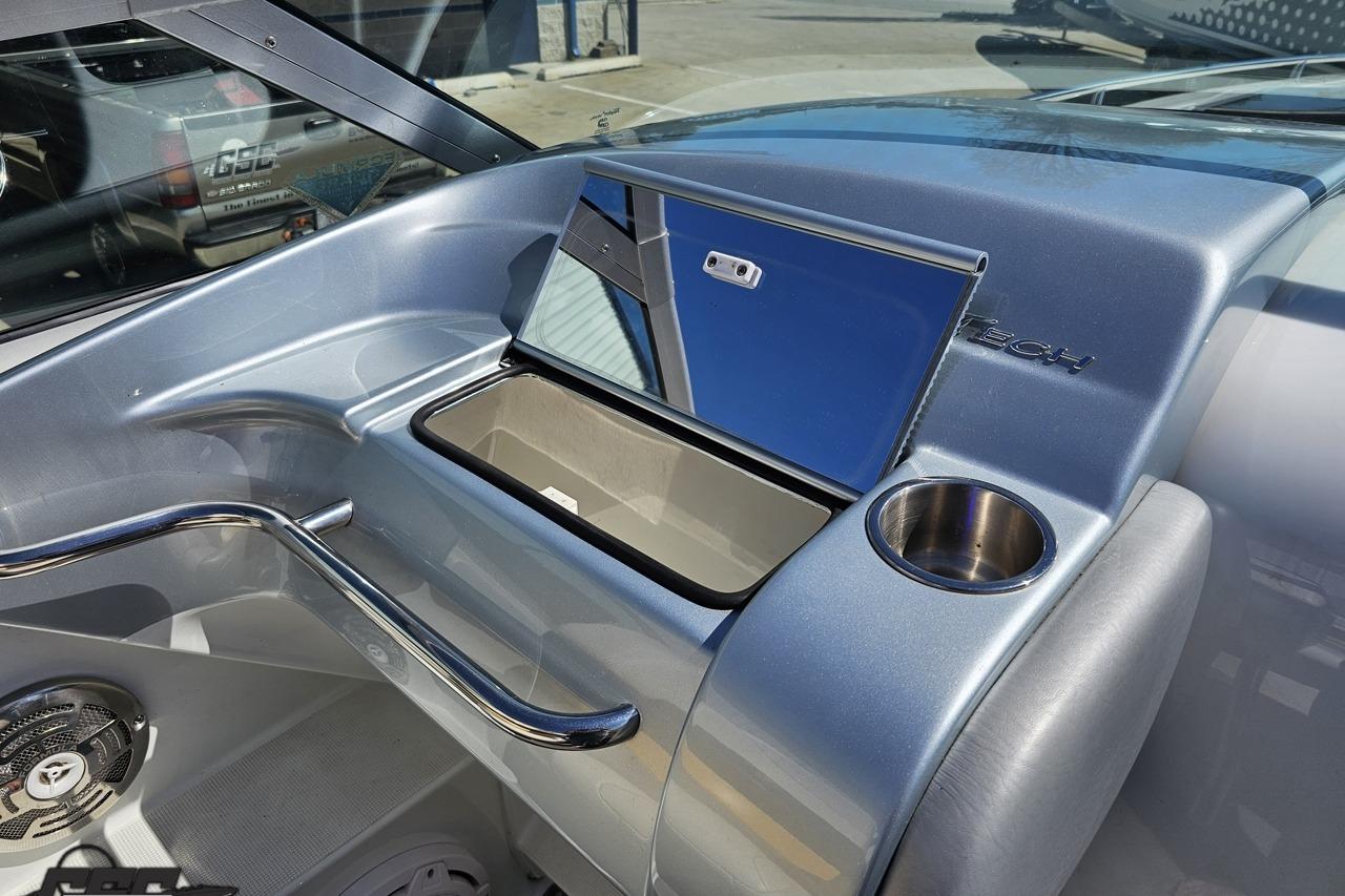 2014 Formula 292 FASTech boat interior with storage compartment and cup holder.