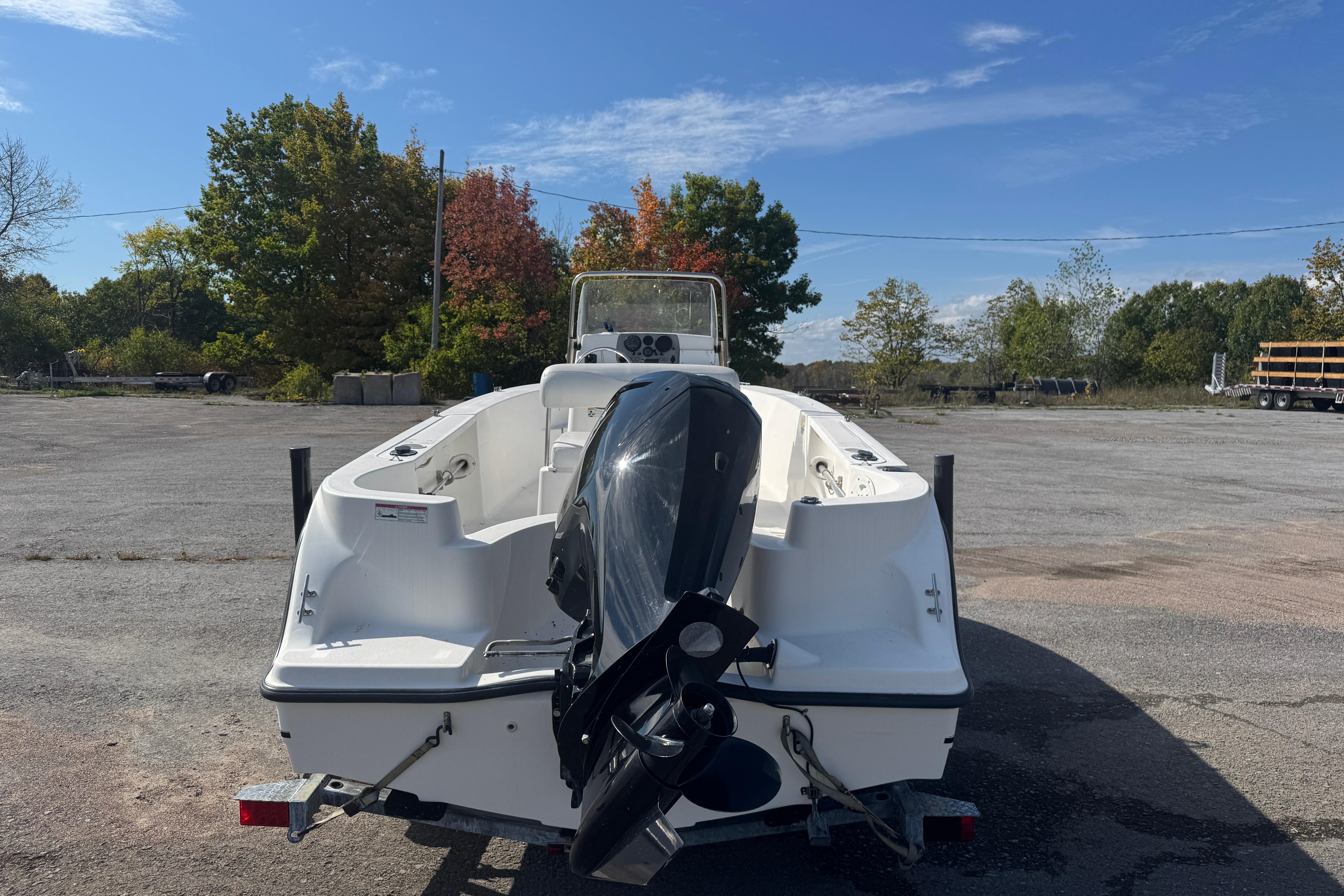2007 Trophy 1703 Center Console boat with outboard motor in a parking lot.