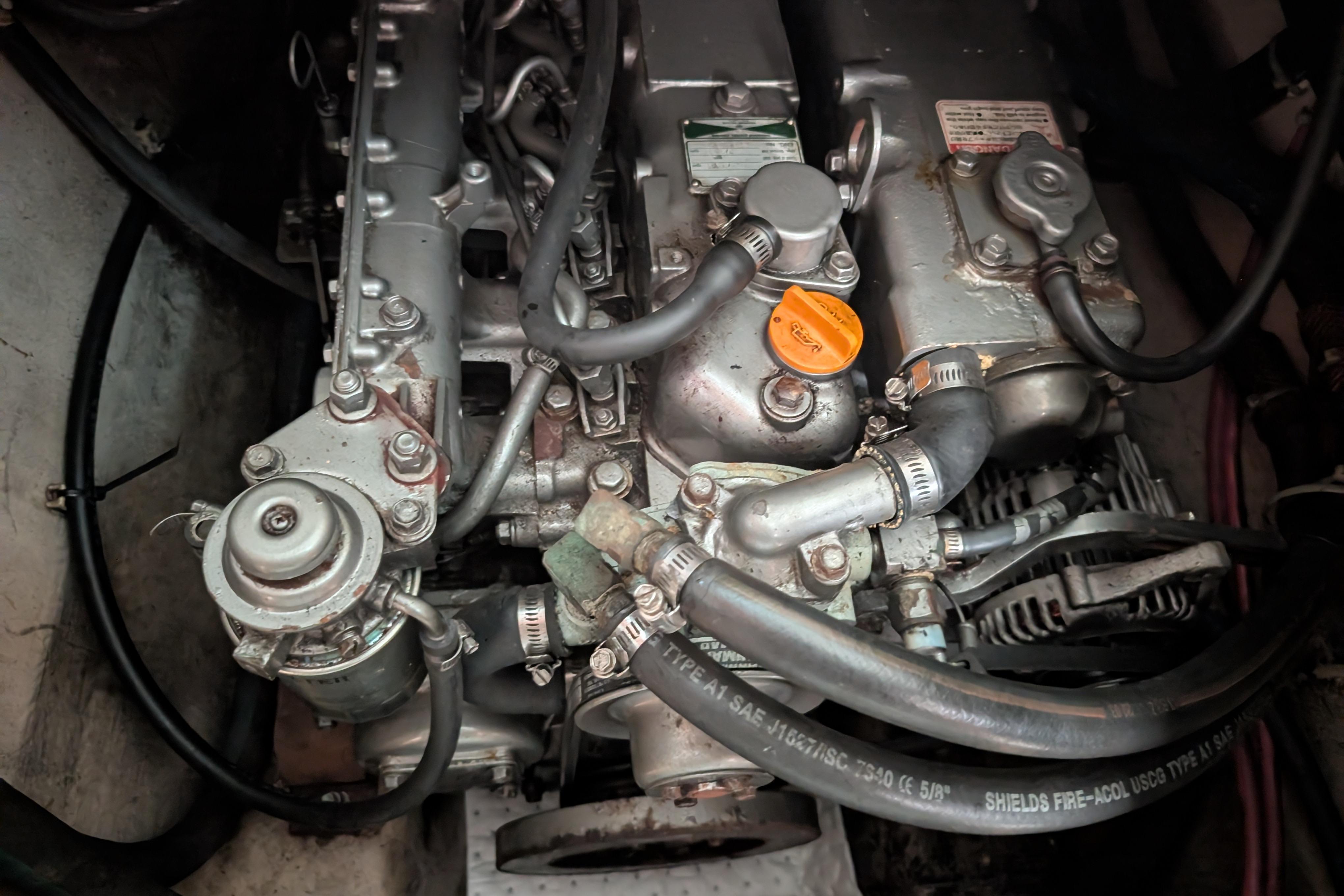 Engine compartment of a 2004 PDQ 34 Powercat, showcasing mechanical components and hoses.