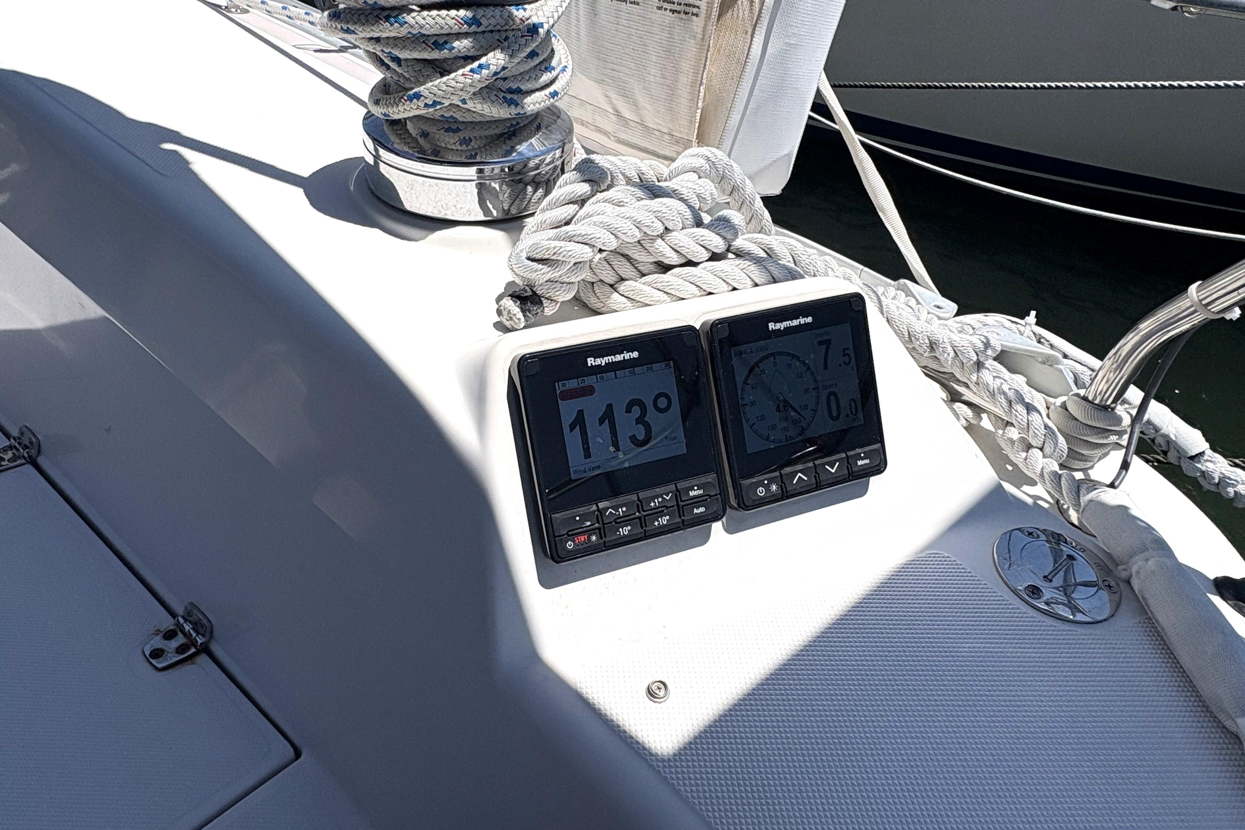 Two navigation instruments on a sailboat display course and speed.