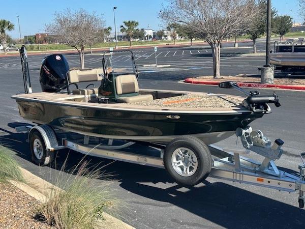 2025 Mako 18 Pro Skiff Backwater Edition on trailer in parking lot.