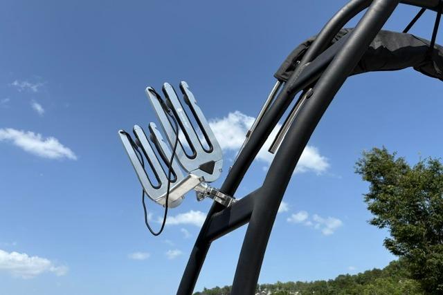 Wakeboard rack on 2024 Tahoe T21 boat against clear blue sky.