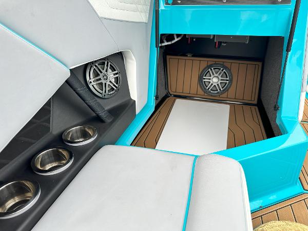 2022 Nautique S23 boat interior with speakers and cup holders.