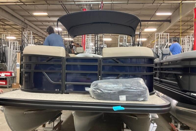 2026 Bennington 22 SSRSE pontoon boat in a warehouse setting.