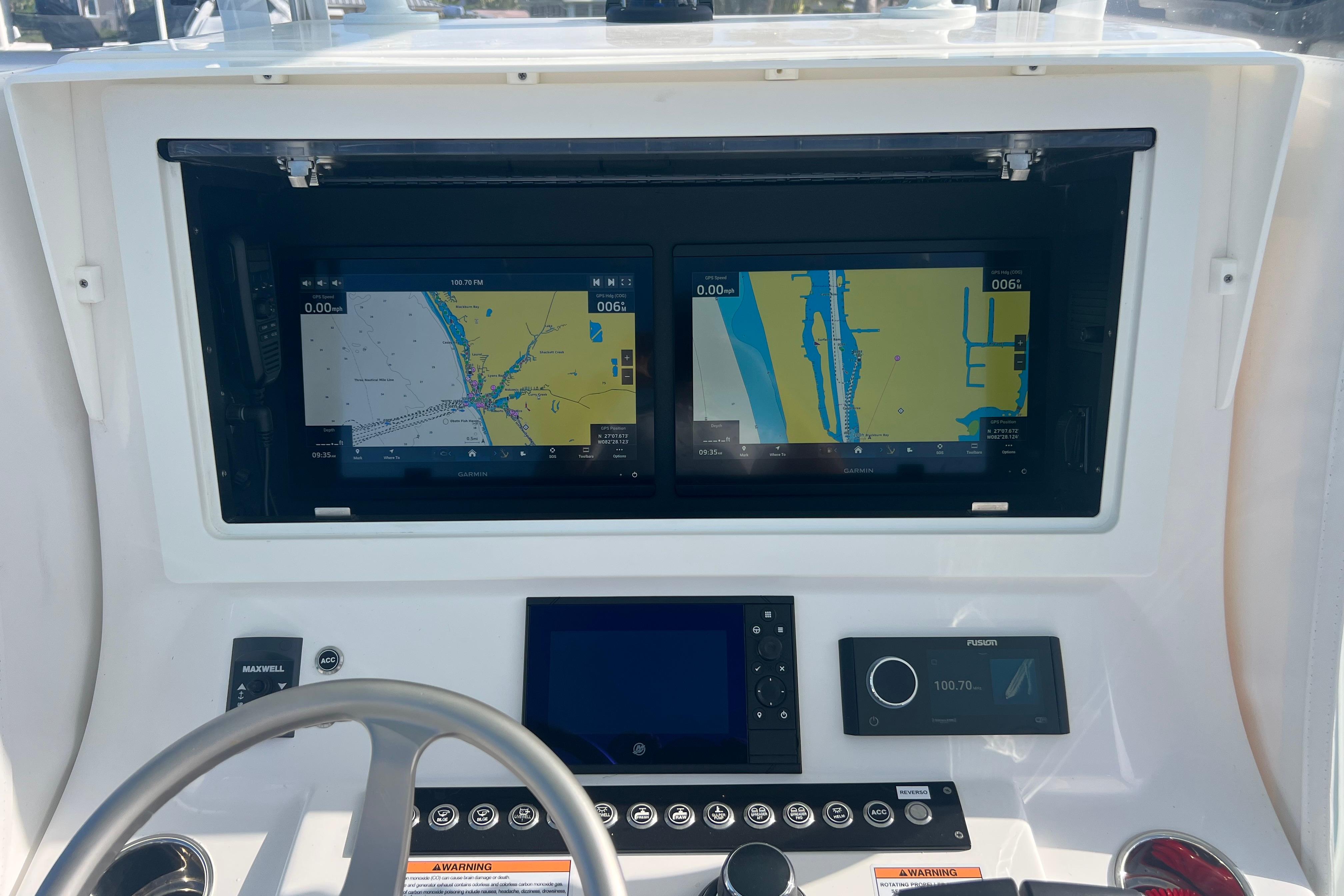 2024 Contender 35 ST boat dashboard with dual navigation screens and control panel.