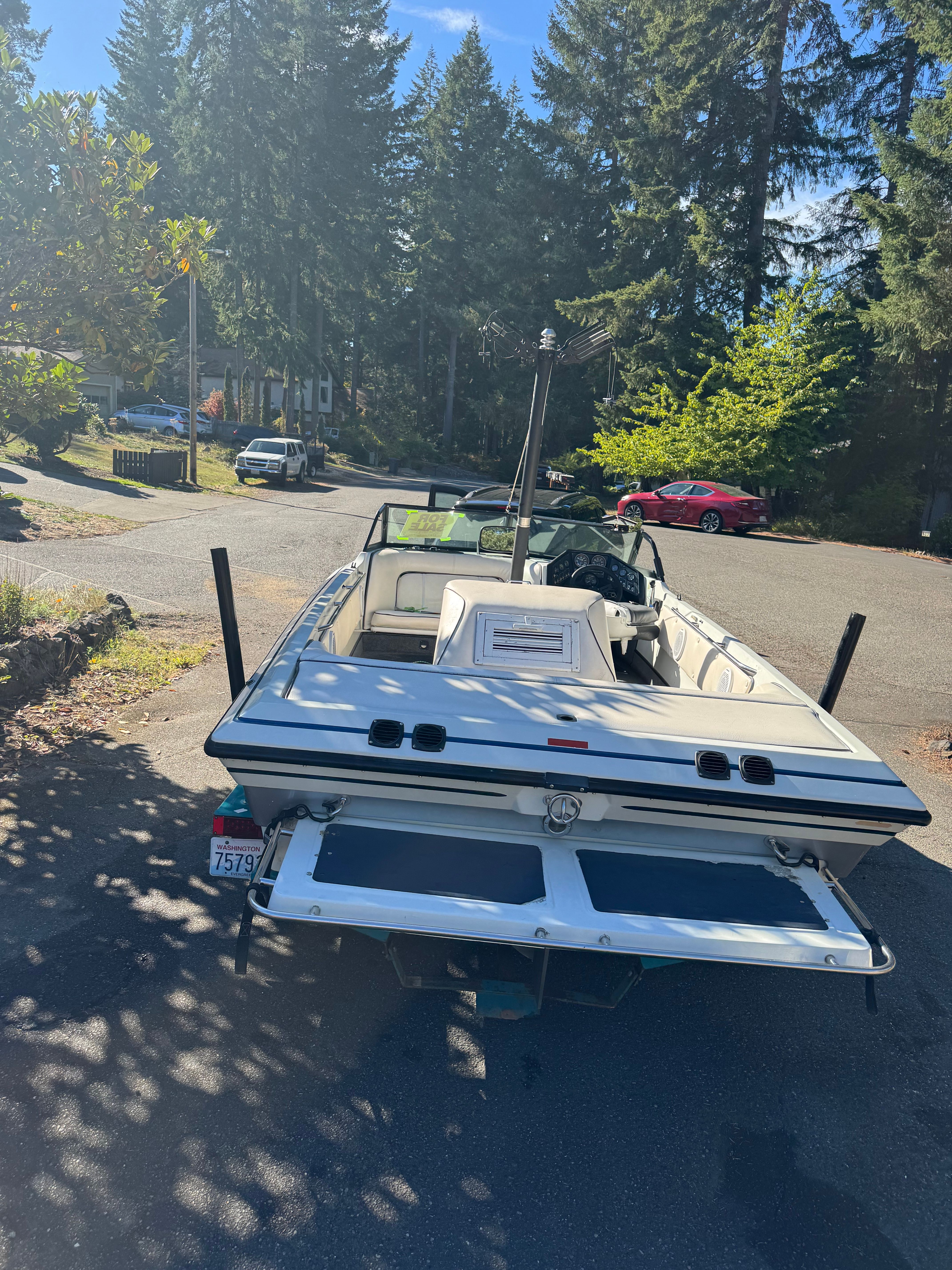 1990 Supra TS6M boat parked in a sunny area.
