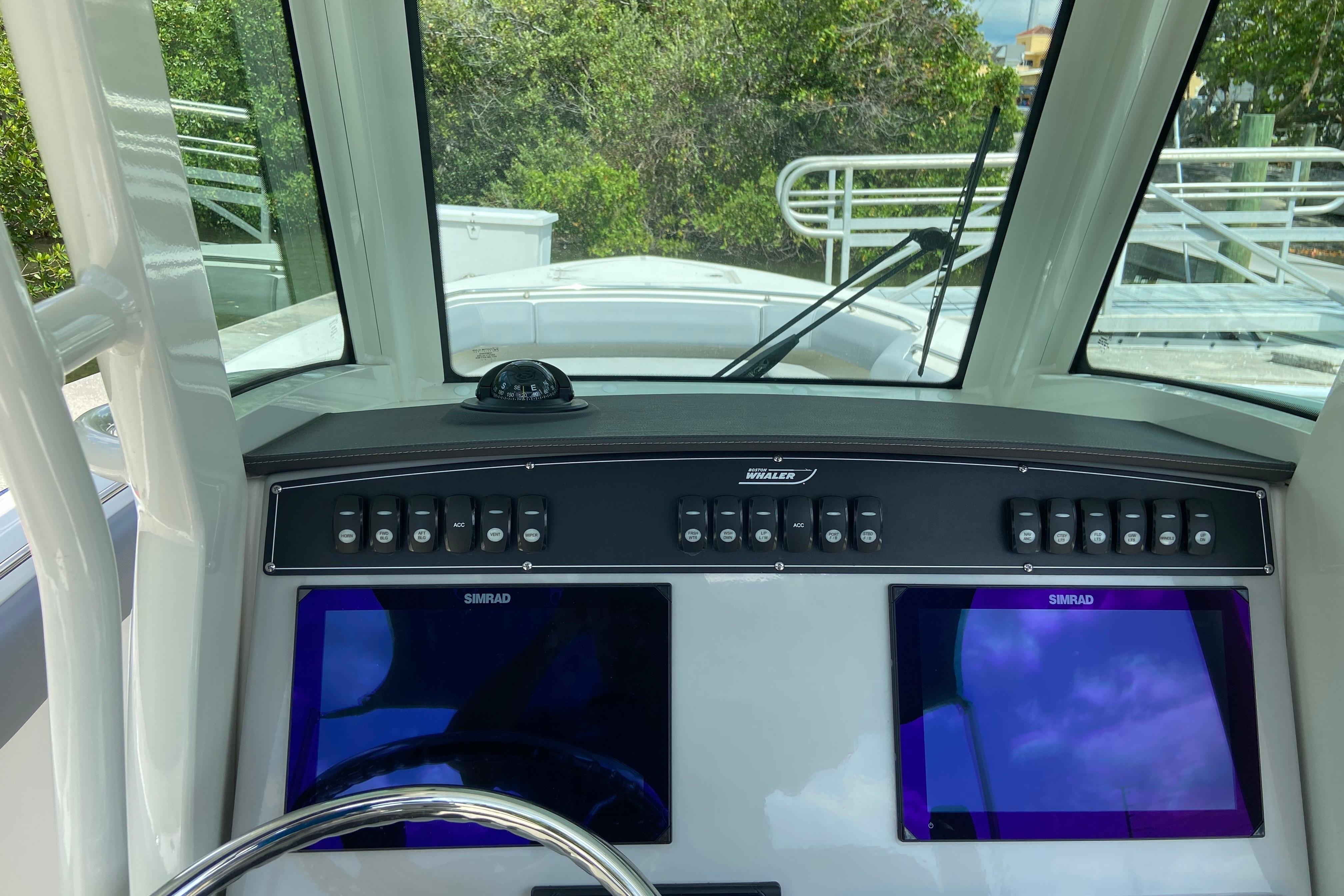 2025 Boston Whaler 280 Outrage dashboard with dual Simrad displays and control panel.