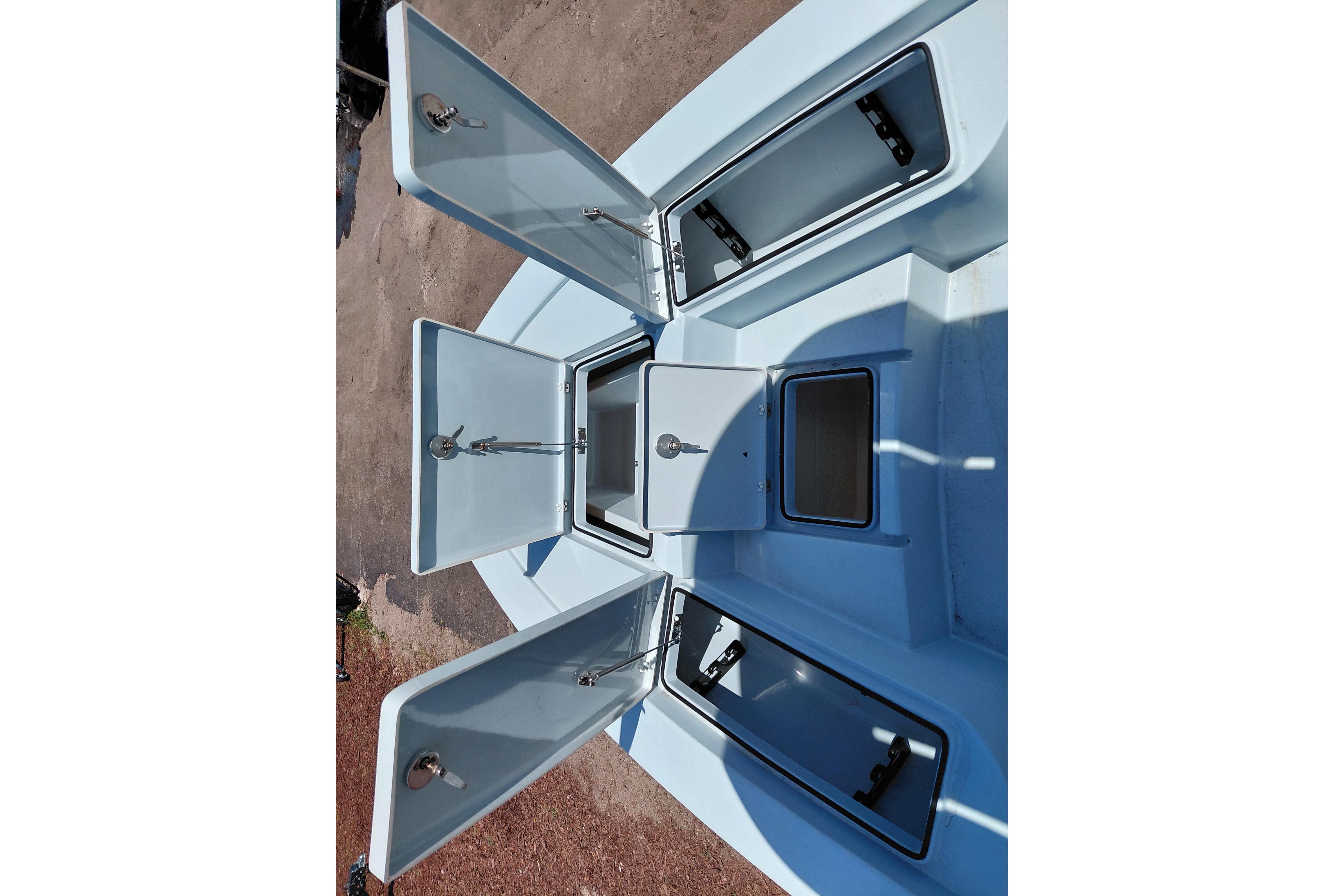 2022 Pathfinder 2300 HPS boat storage compartments open, showcasing ample space and organization.