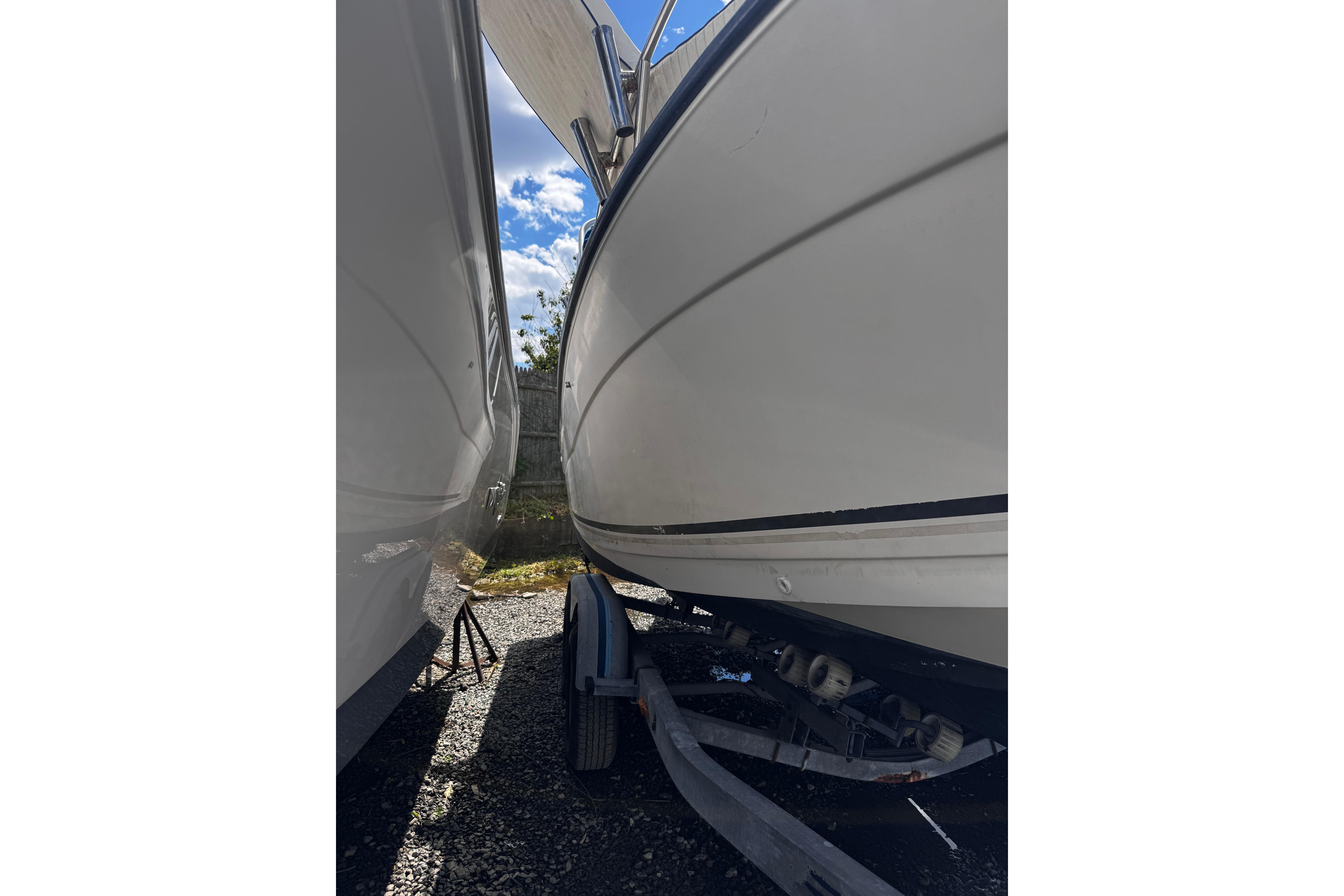 2003 Palm Beach 2200 Dual Console boat on trailer, parked outdoors.