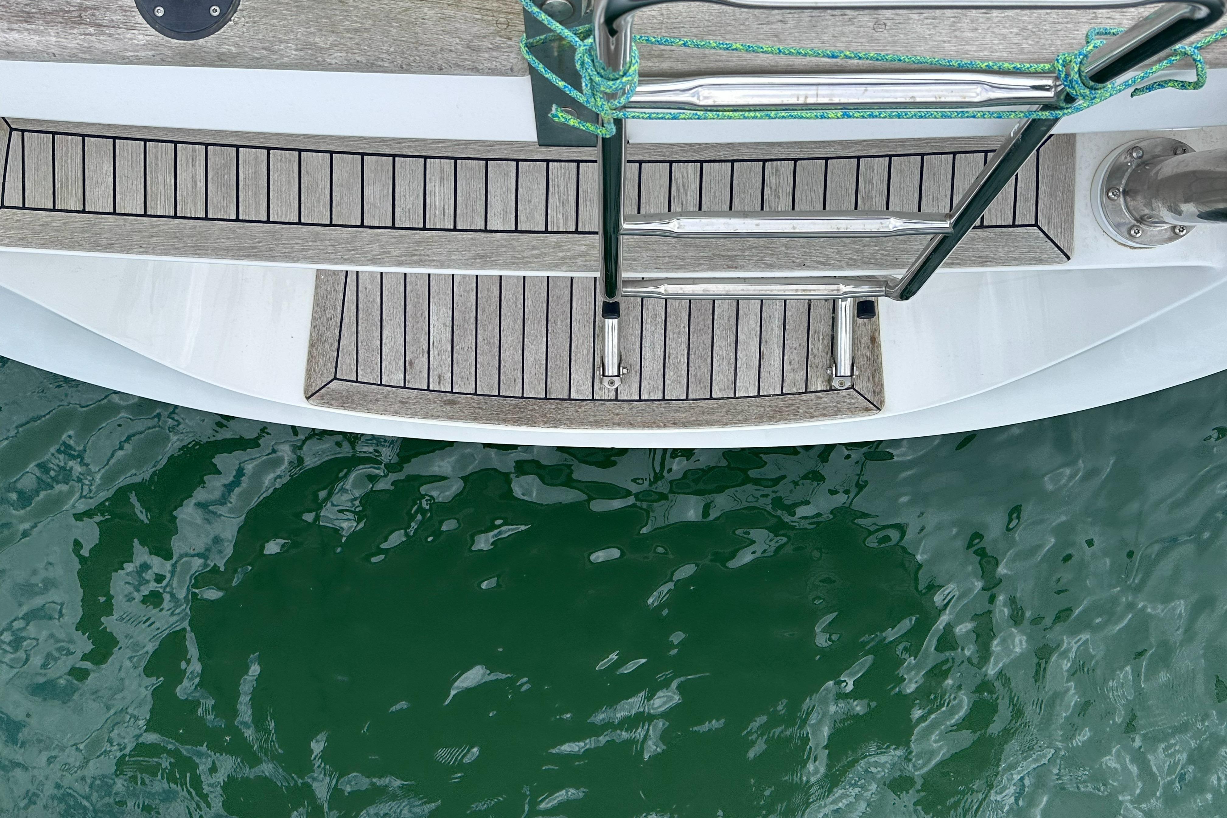 Teak deck and swim ladder of 2020 Hallberg-Rassy 48 MkII yacht.