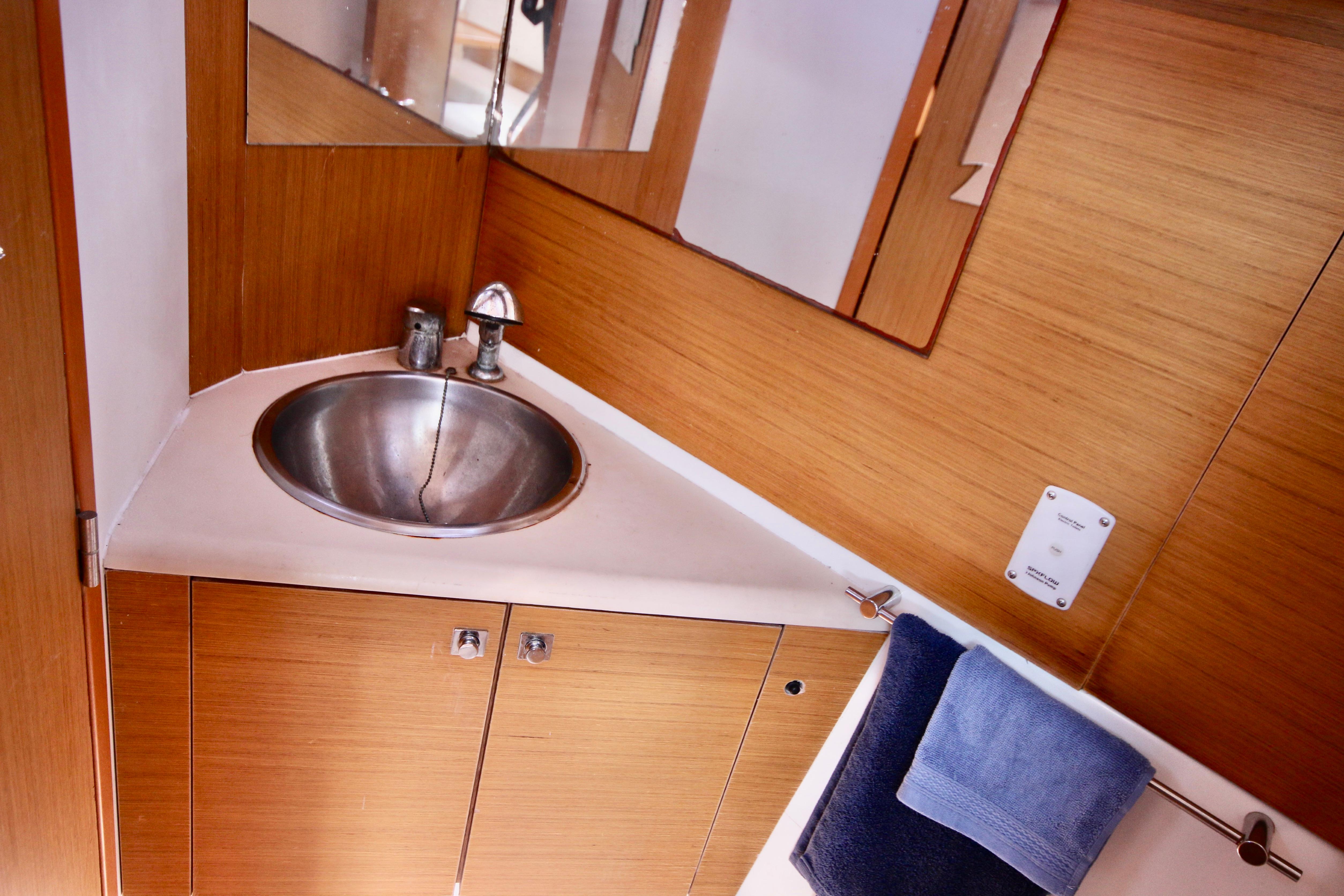 Bathroom interior of 2009 Jeanneau Sun Odyssey 44i yacht with stainless steel sink.