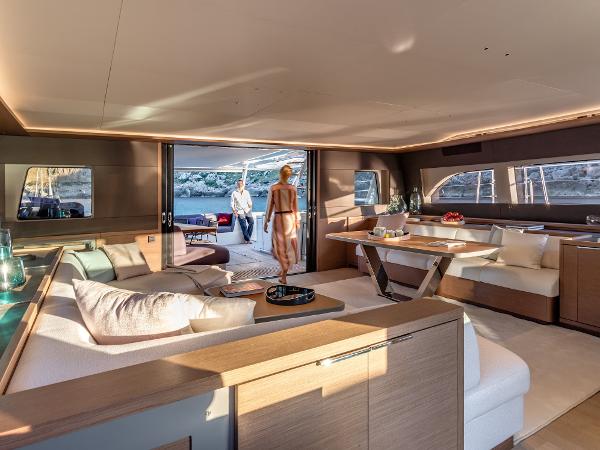 Luxurious interior of 2025 Lagoon SIXTY 7 yacht with elegant seating and dining area.