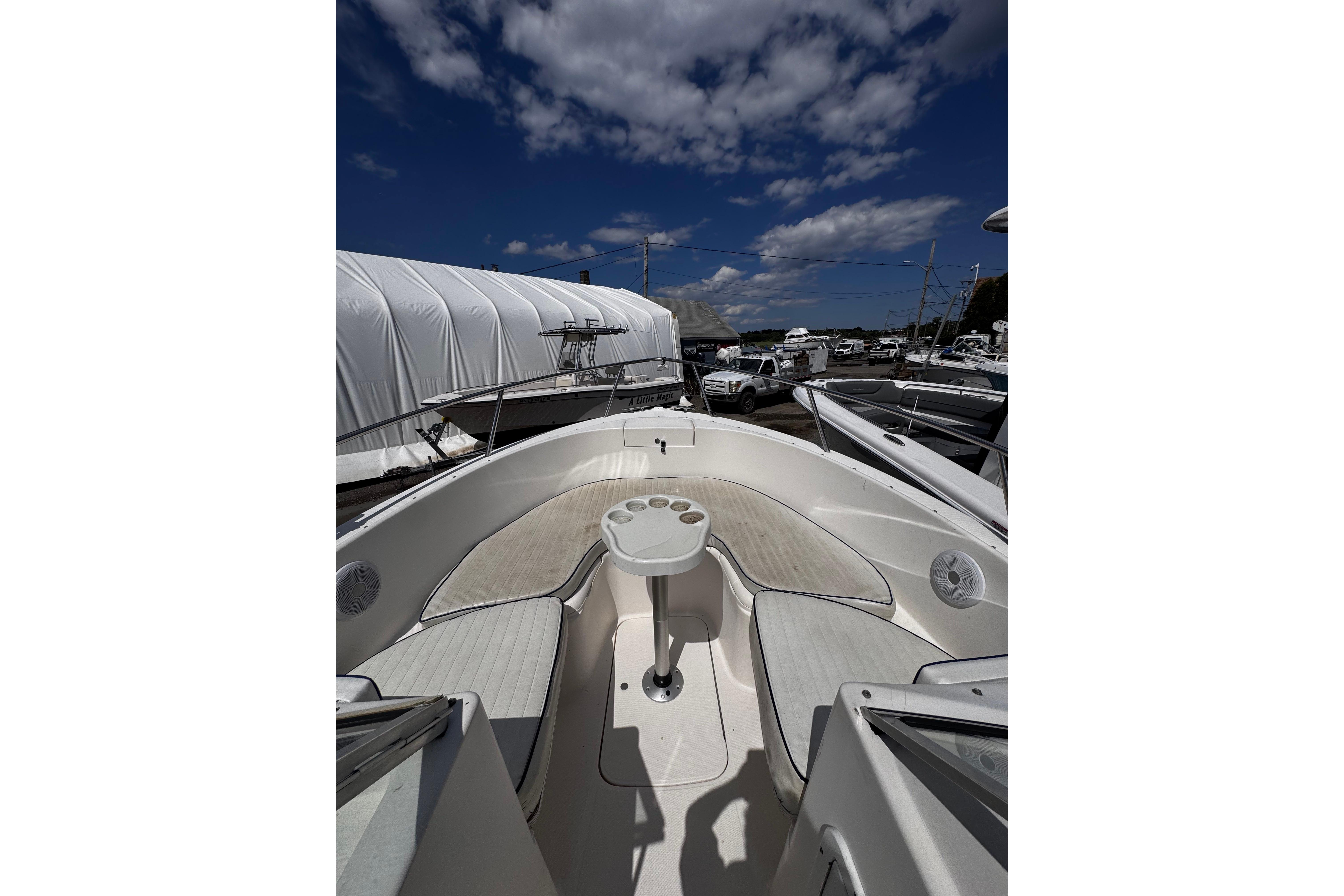 2003 Palm Beach 2200 Dual Console boat with spacious seating under a partly cloudy sky.