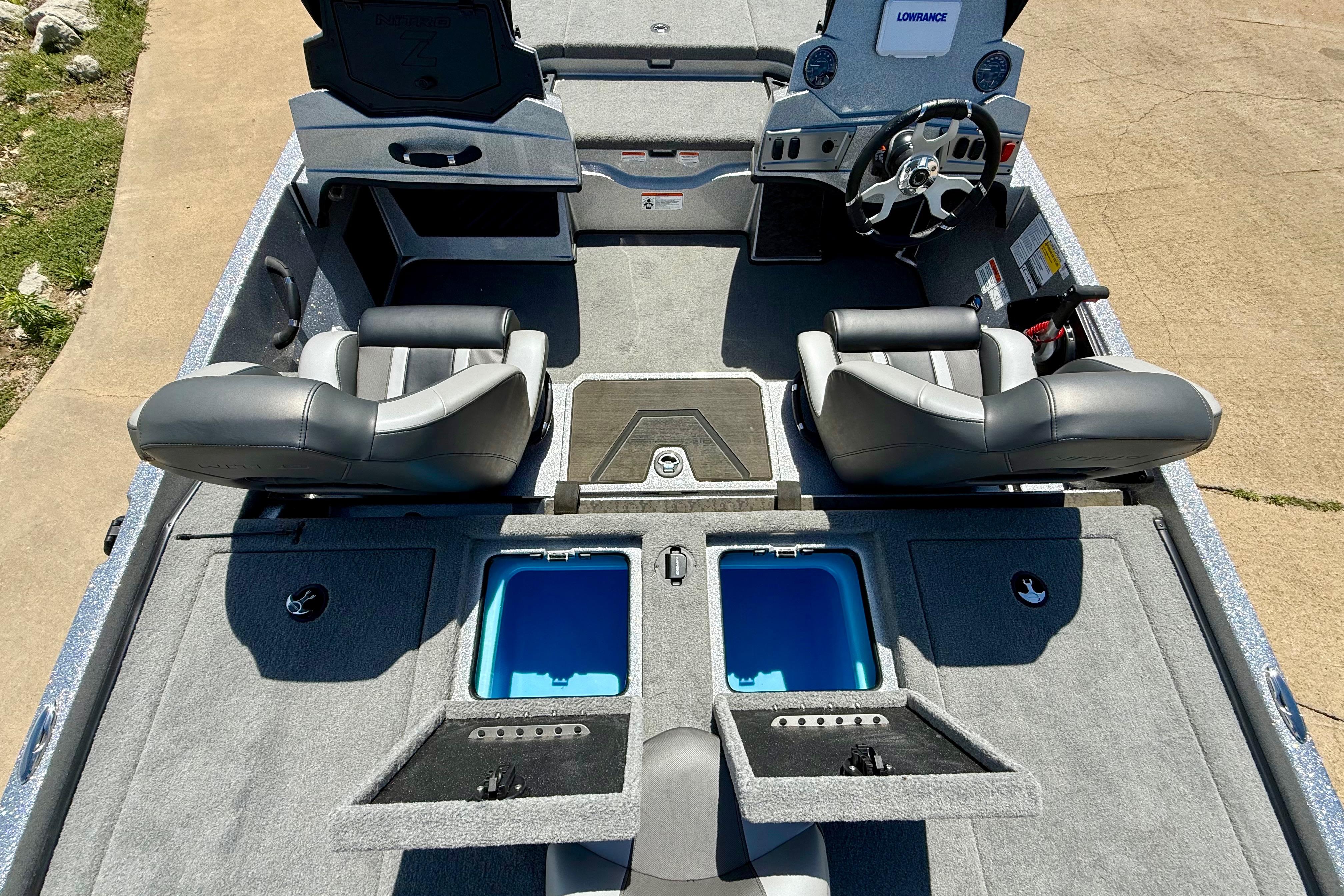 2026 Nitro Z19 XL boat interior with dual seats, steering wheel, and storage compartments.