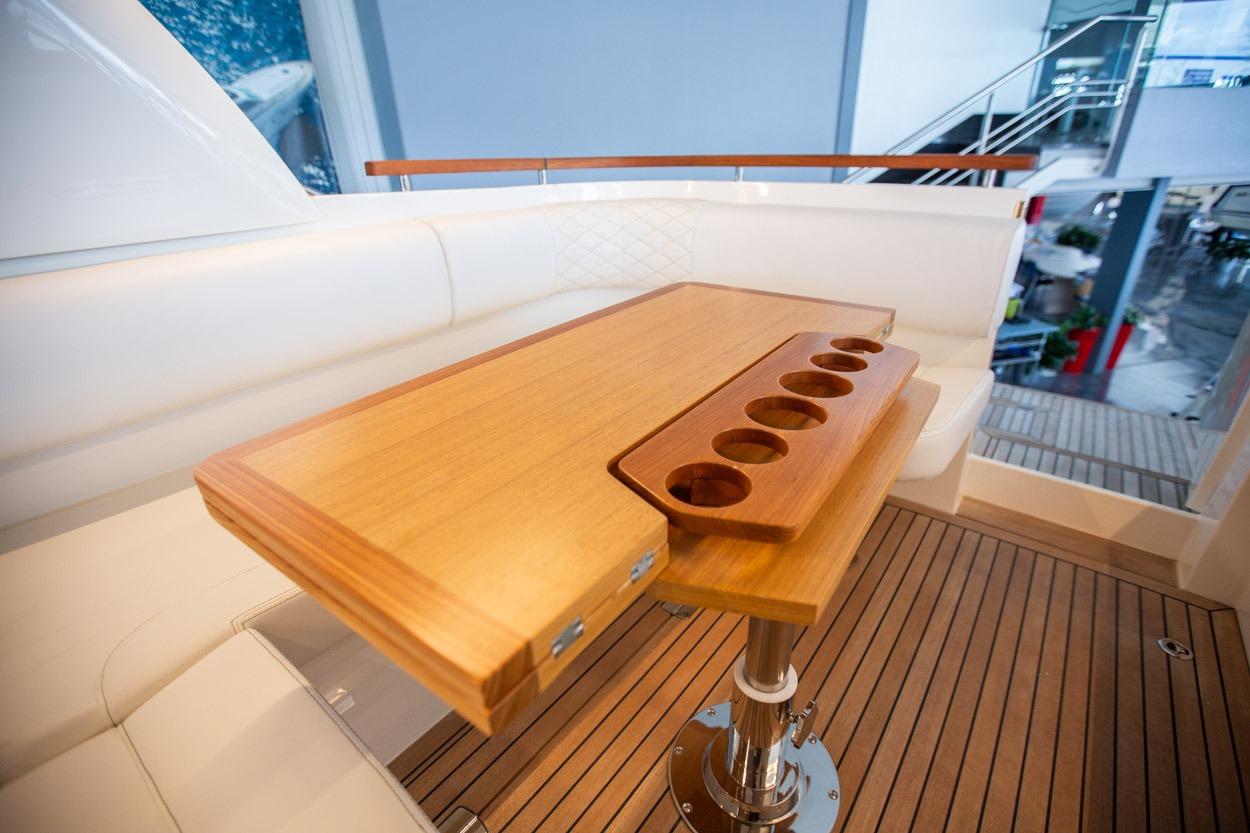 Luxurious interior of 2022 Marex 360 Cabriolet Cruiser with elegant wooden table and seating.
