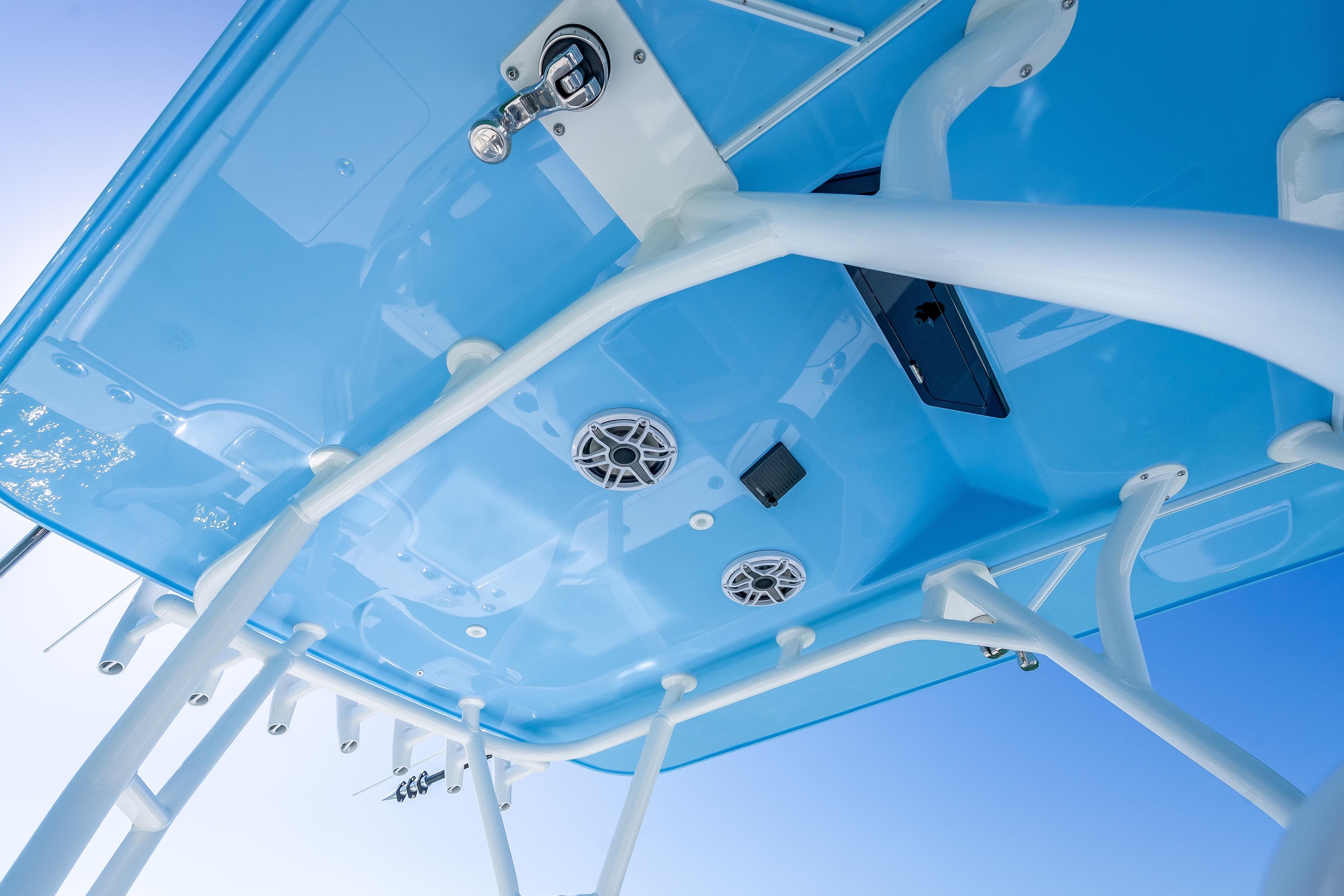 2026 Yellowfin 32 Offshore boat's blue T-top with speakers and rod holders.