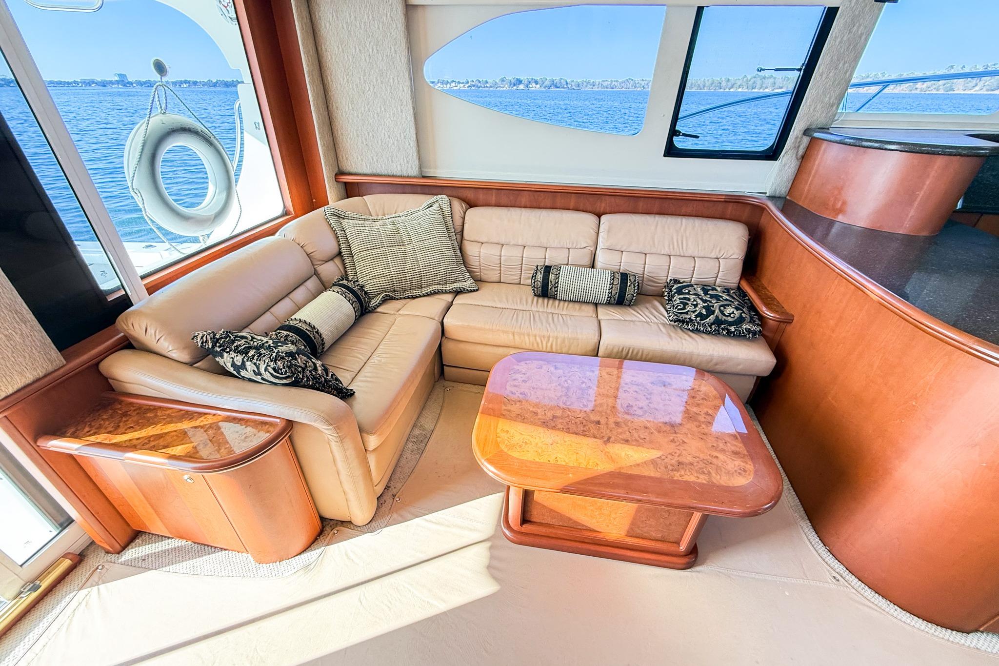 Luxurious interior of 2004 Silverton 48 Convertible yacht with plush seating and elegant decor.