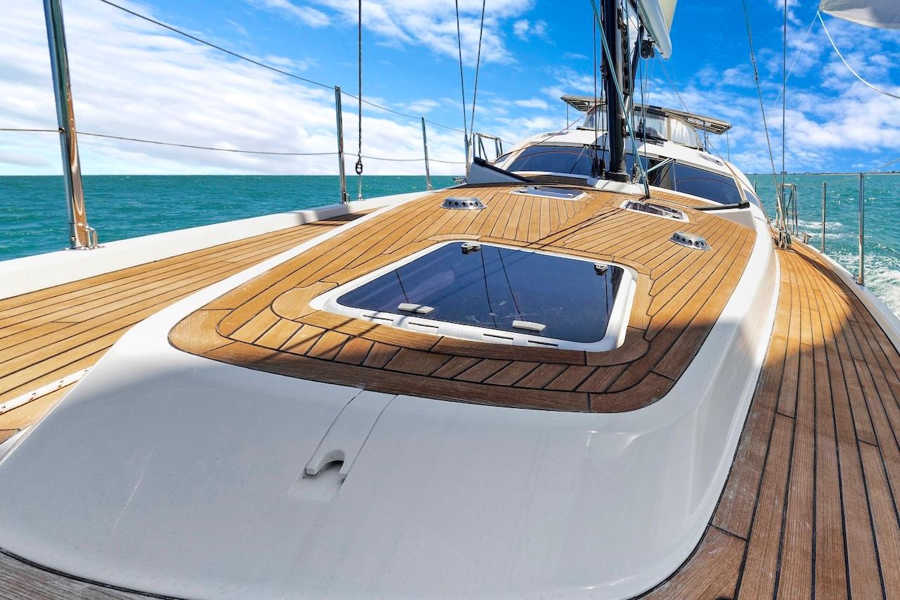 Luxurious 2011 Southerly 57 RS yacht deck with teak finish, sailing on open sea.