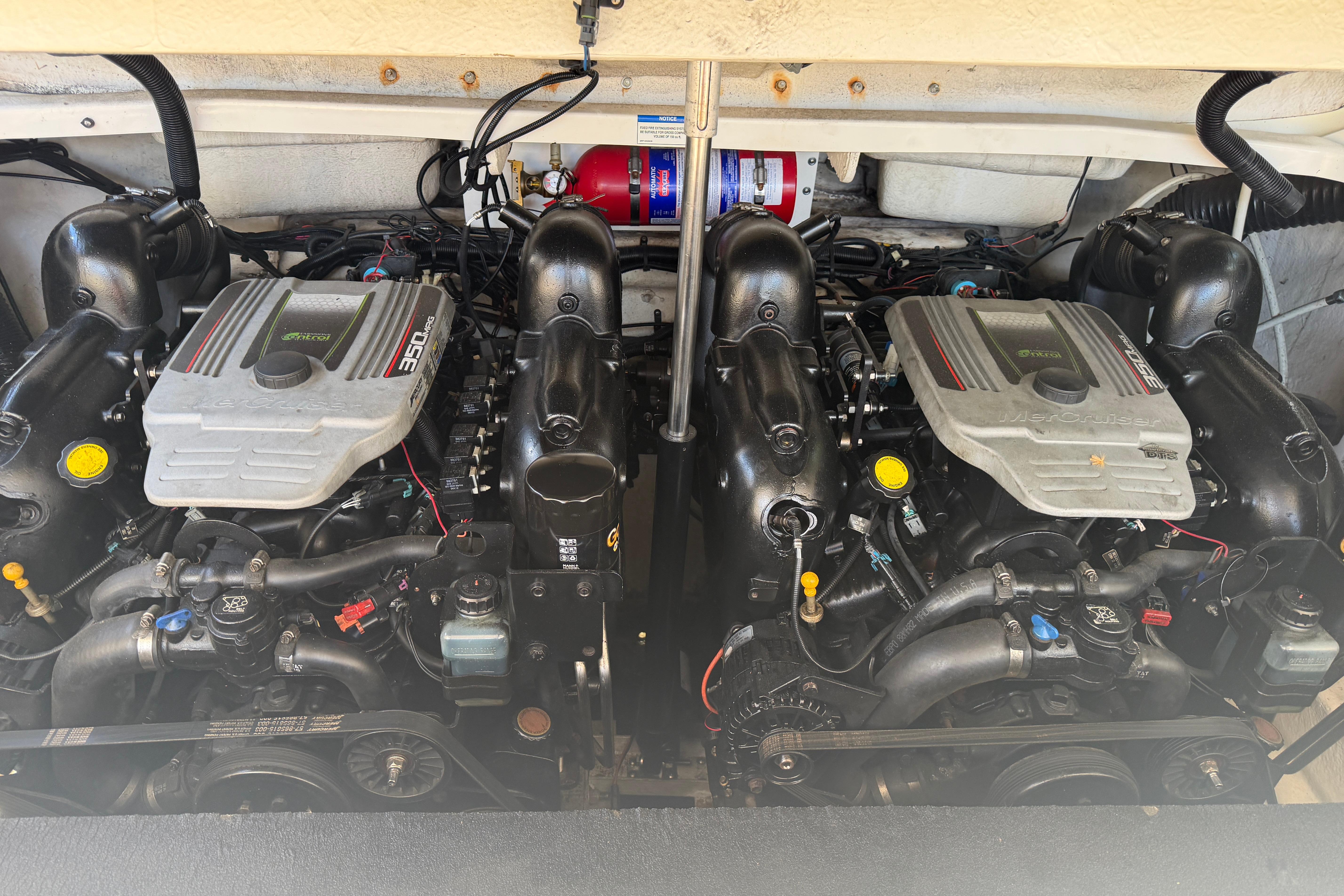 Twin engines of a 2013 Sea Ray 300 SLX boat, showcasing detailed mechanics.
