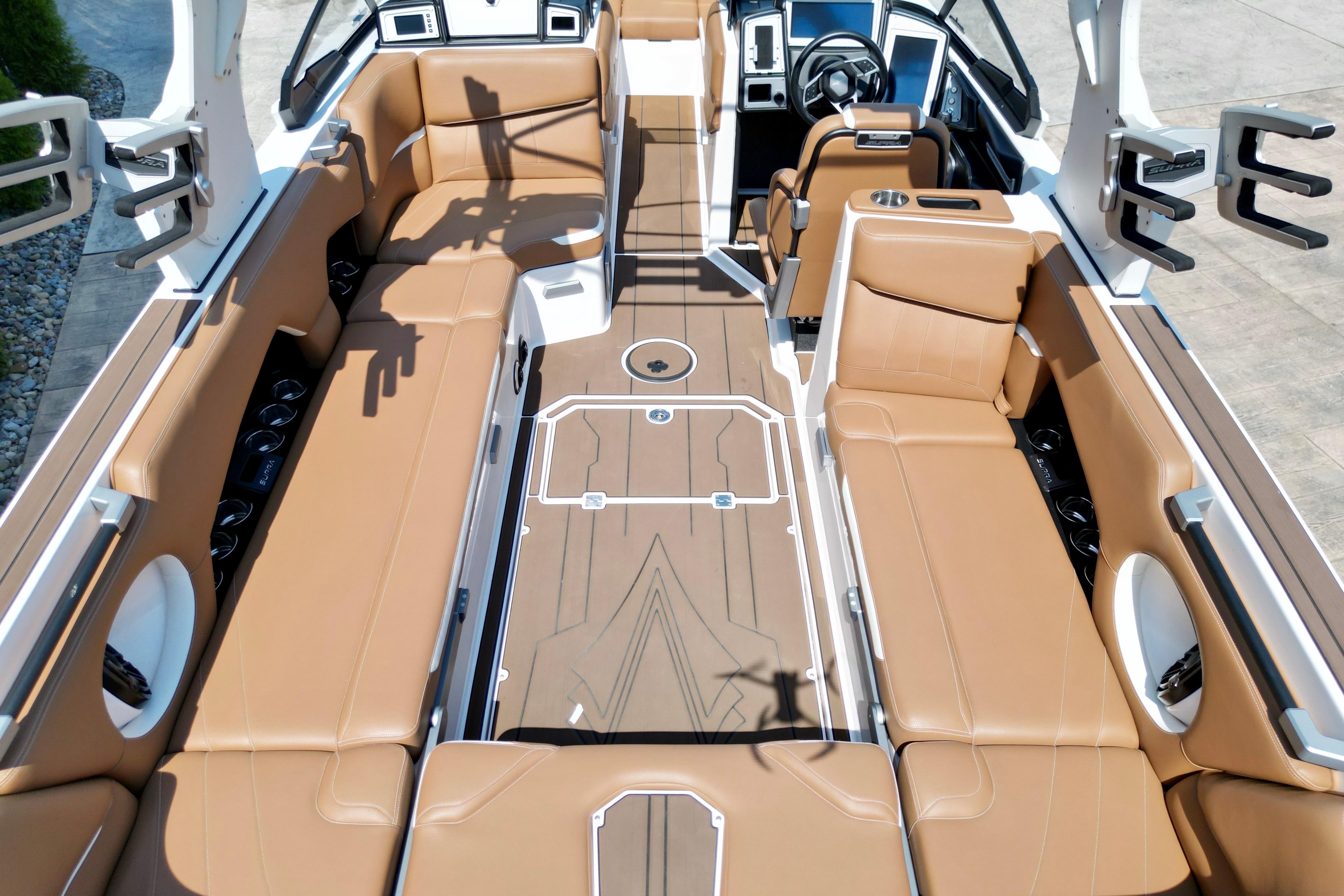 2021 Supra SE boat interior with tan leather seating and modern dashboard design.