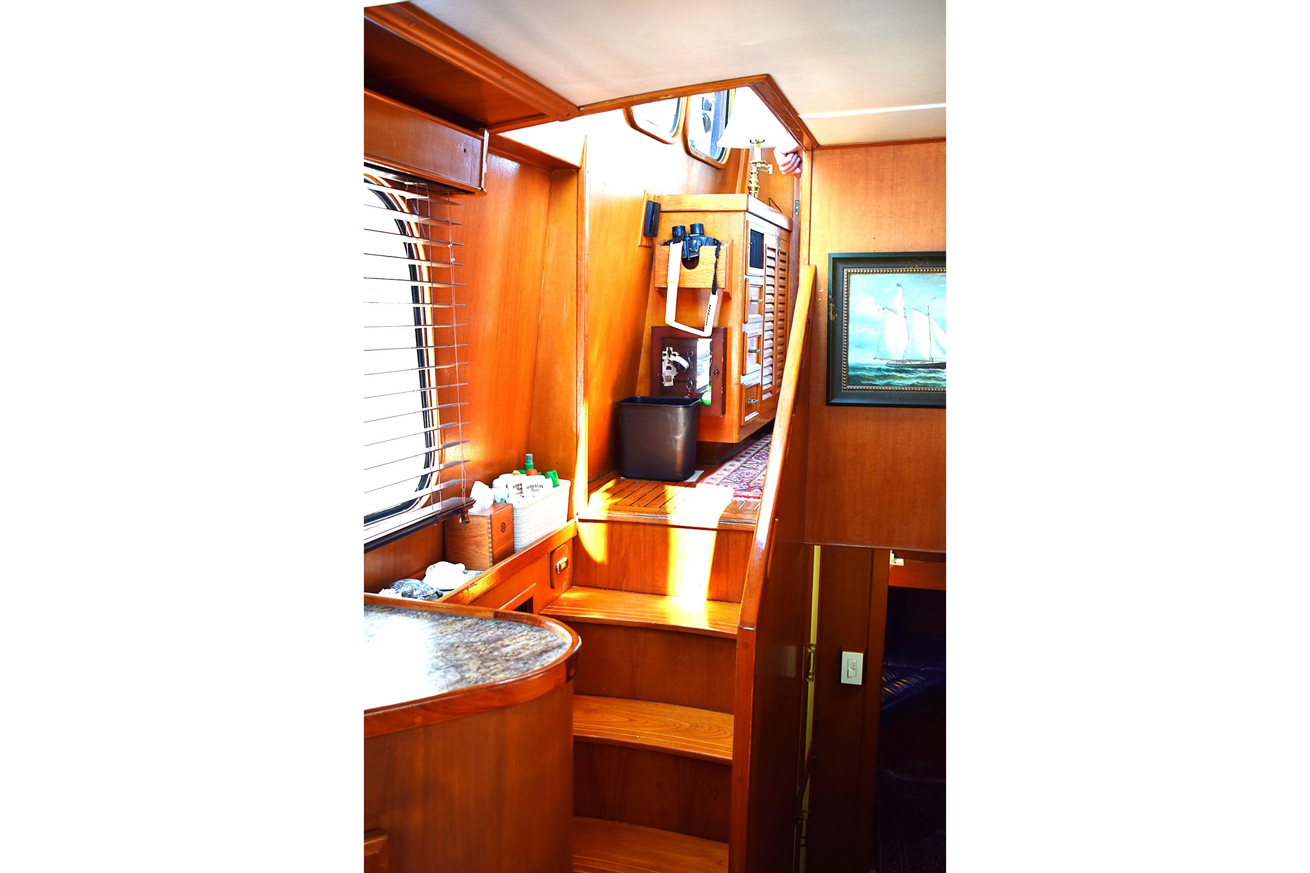 Interior of 1980 Cheoy Lee 52 Motorsailer with wooden stairs and nautical decor.