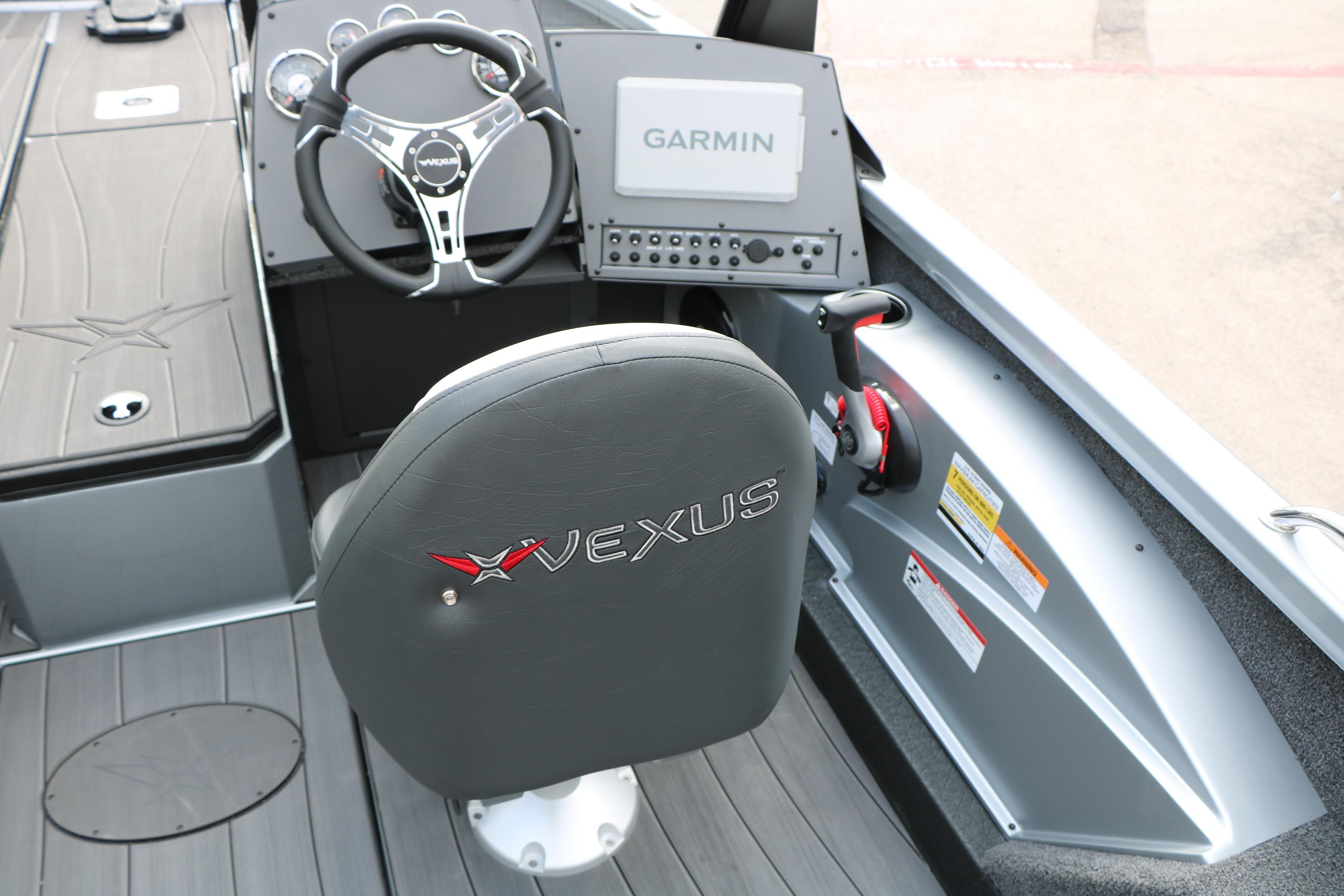 Interior of 2026 Vexus ADX 190 boat with Garmin navigation system and steering wheel.