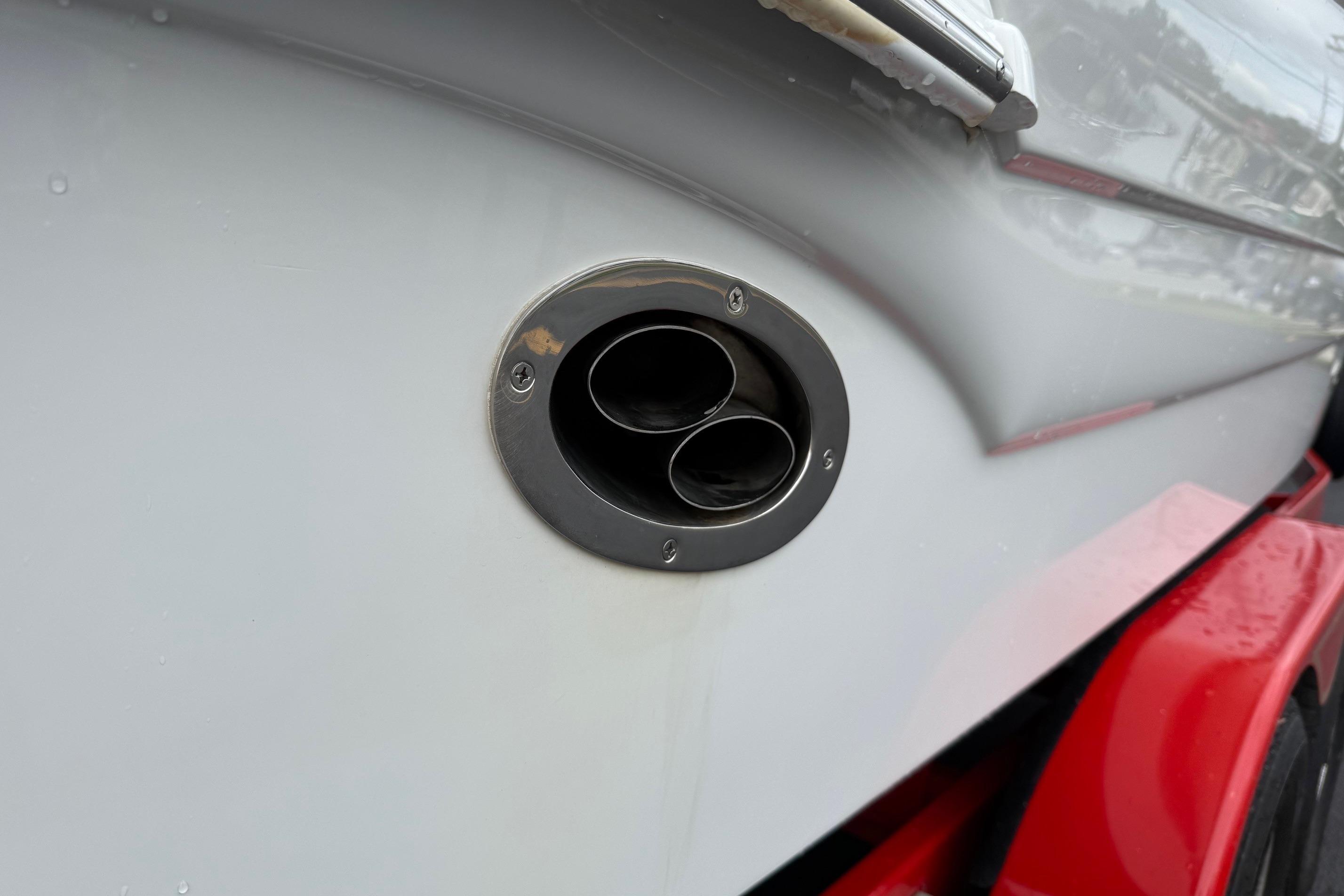 Close-up of 2005 Crownline 250 CR boat exhaust outlet on a red trailer.